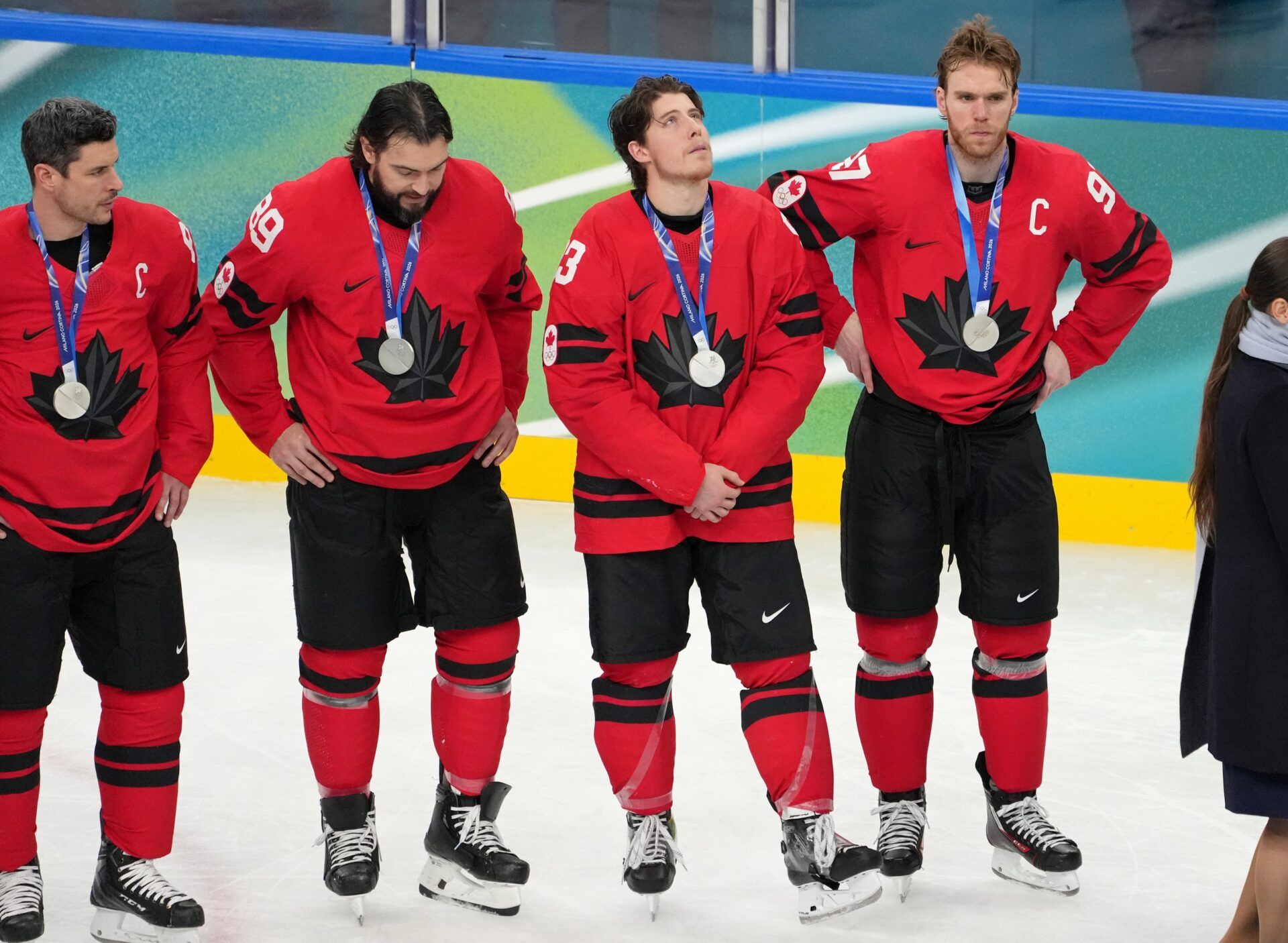 Connor McDavid of Canada (right) and teammates react after losing to the United States in the men's ice hockey gold medal game during the Milano Cortina 2026 Olympic Winter Games at Milano Santagiulia Ice Hockey Arena.