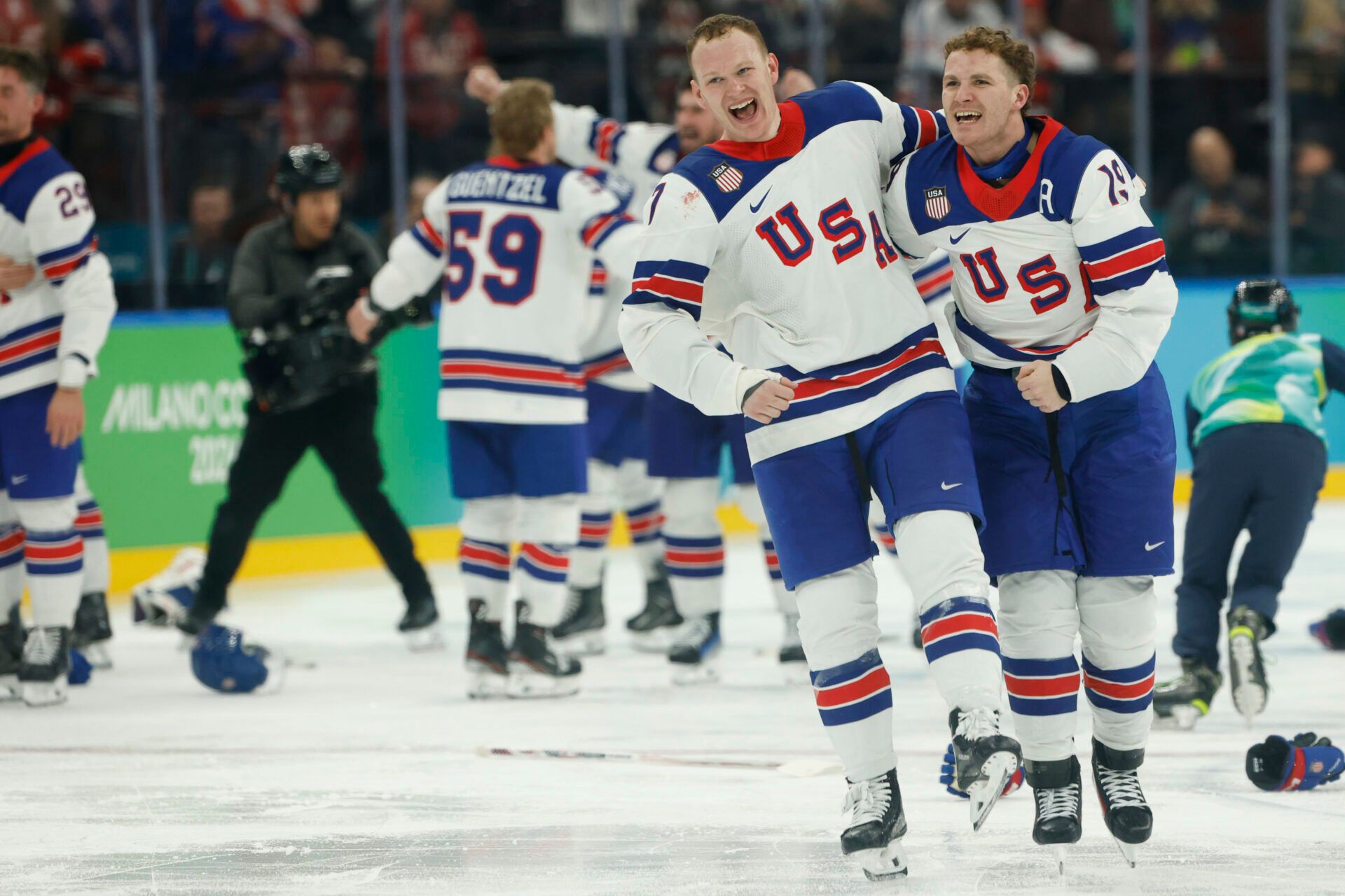 Brady Tkachuk #7 of Team United States and Matthew Tkachuk #19 of Team United States celebrate after their game against Team Canada during the Milano Cortina 2026 Olympic Winter Games at Milano Santagiulia Ice Hockey Arena.