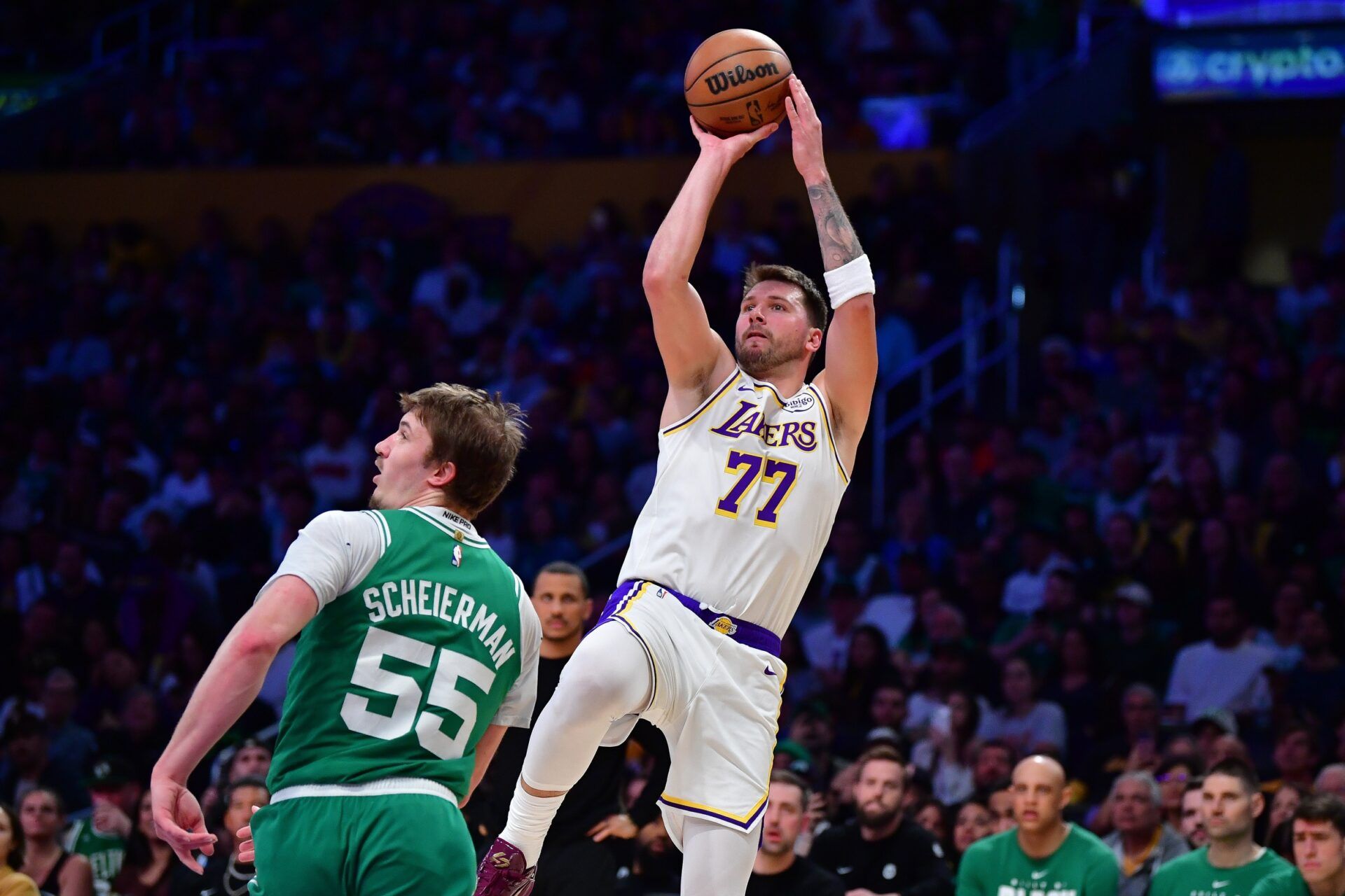 Los Angeles Lakers guard Luka Doncic (77) shoots against Boston Celtics guard Baylor Scheierman (55) during the second half at Crypto.com Arena.