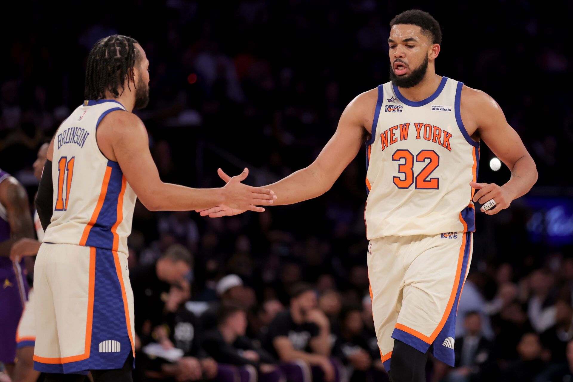 New York Knicks center Karl-Anthony Towns (32) high fives guard Jalen Brunson (11) during the third quarter against the Los Angeles Lakers at Madison Square Garden.