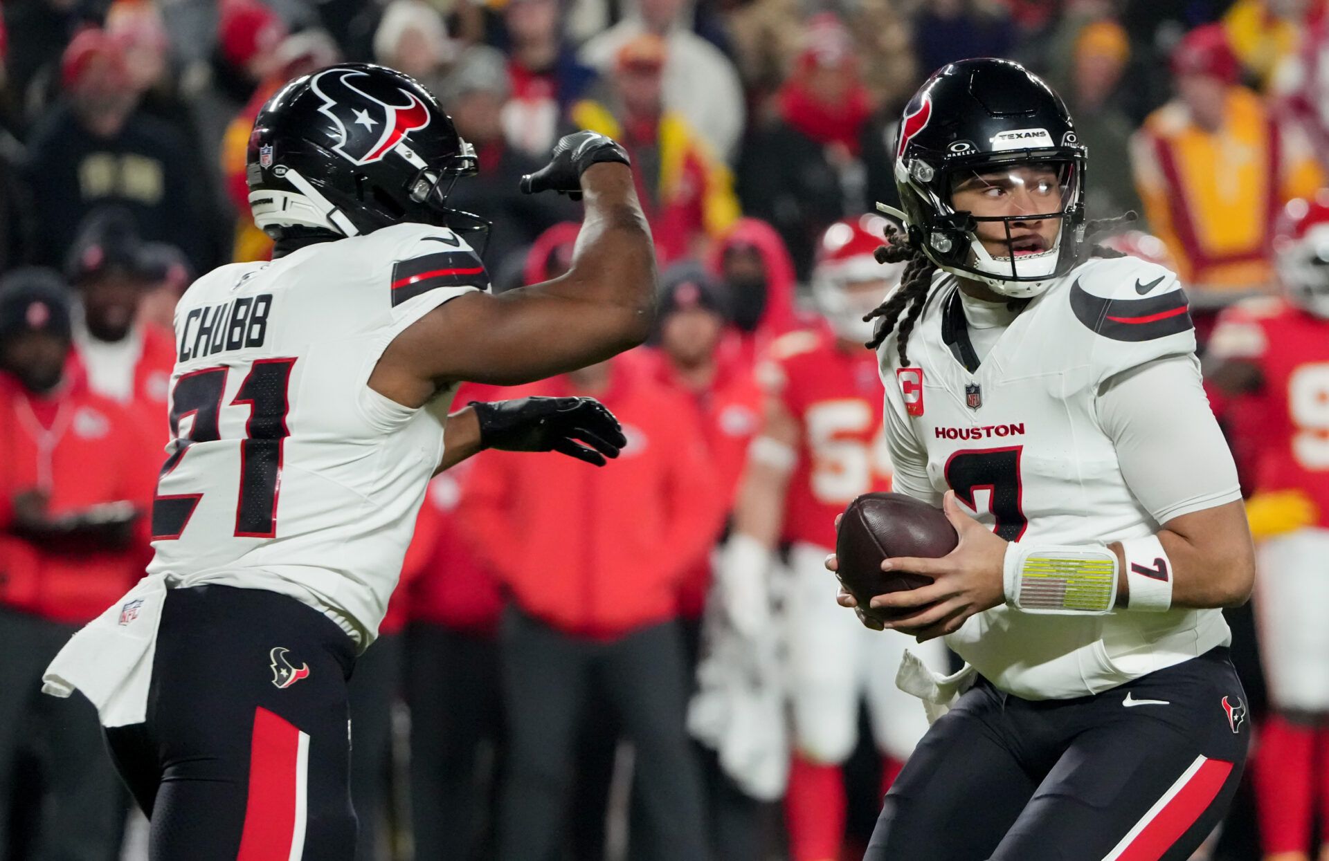 Houston Texans quarterback C.J. Stroud (7) fakes a handoff to Houston Texans running back Nick Chubb (21) during the second quarter at GEHA Field at Arrowhead Stadium.