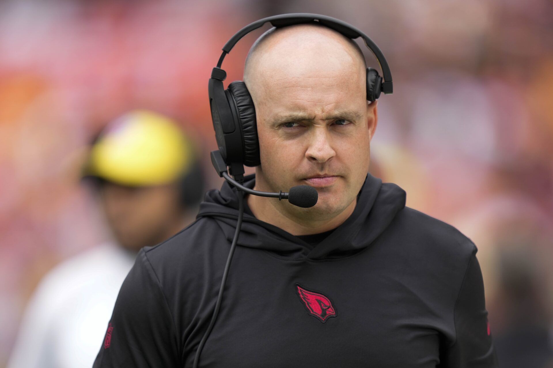 Arizona Cardinals offensive coordinator Drew Petzing walks on the sideline before the game against the Washington Commanders at FedExField.
