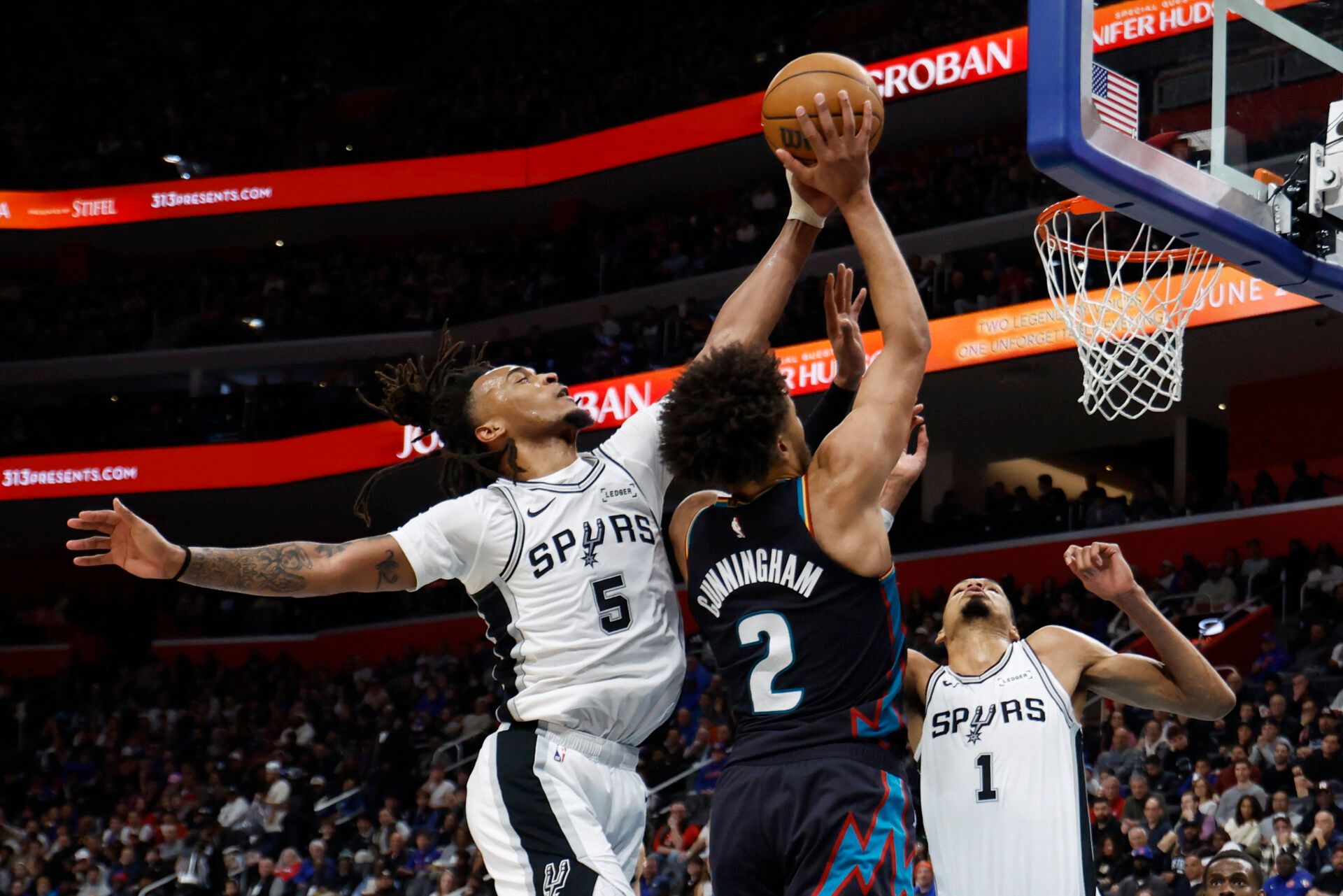 San Antonio Spurs guard Stephon Castle (5) blocks a shot by Detroit Pistons guard Cade Cunningham (2) in the second half at Little Caesars Arena.