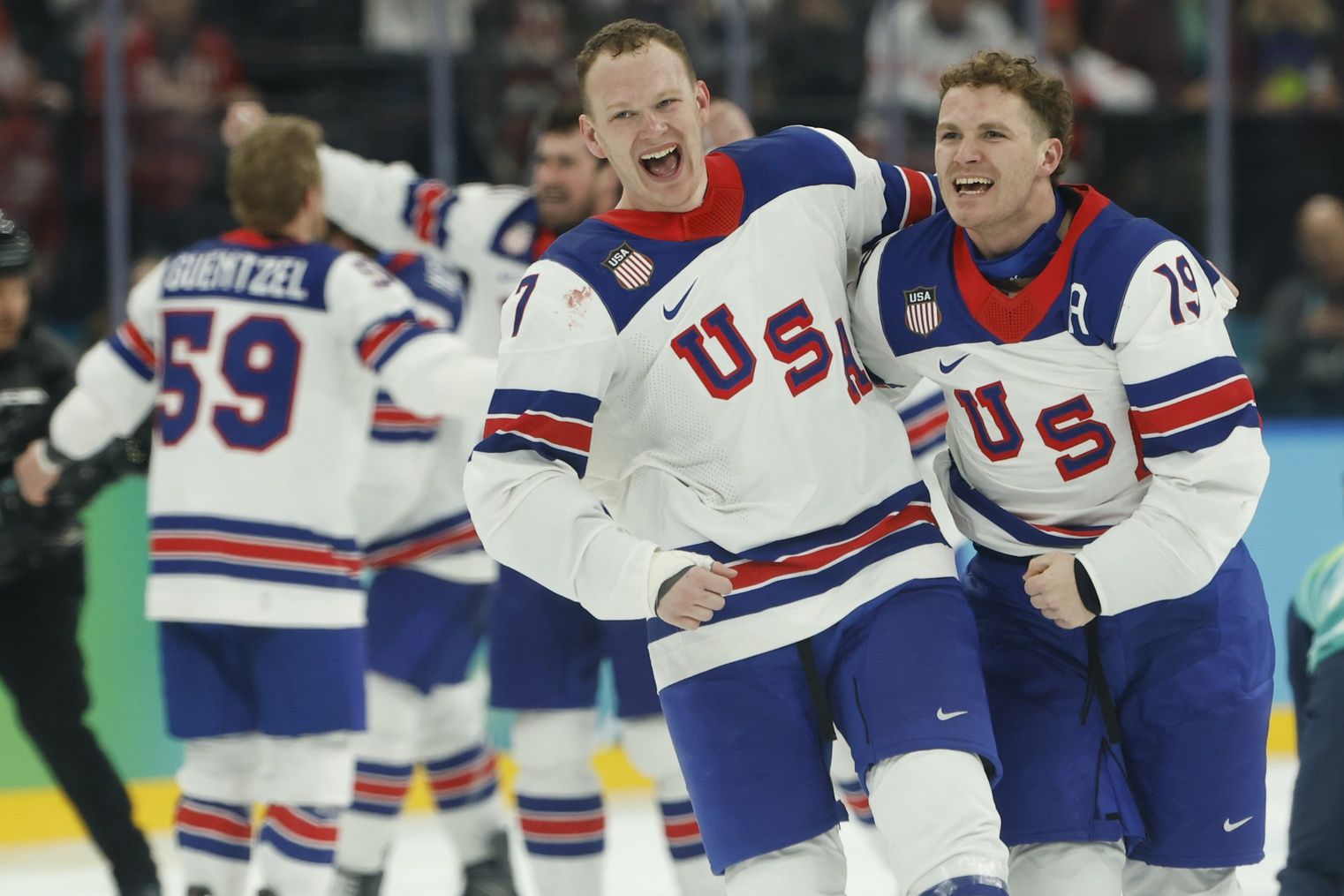 Brady Tkachuk #7 of Team United States and Matthew Tkachuk #19 of Team United States celebrate after their game against Team Canada during the Milano Cortina 2026 Olympic Winter Games at Milano Santagiulia Ice Hockey Arena.