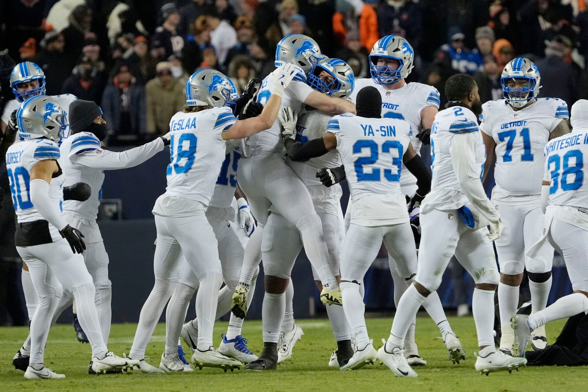 Detroit Lions place kicker Jake Bates (39) celebrates with teammates after kicking a game-winning field goal against the Chicago Bears at Soldier Field.