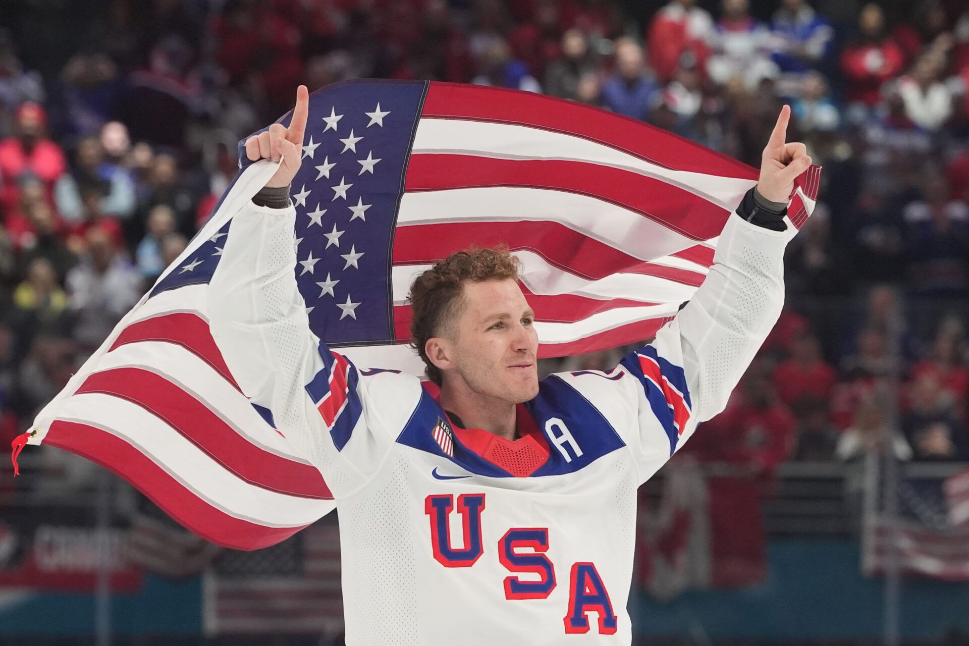 Matthew Tkachuk (19) of the United States celebrate after defeating Canada in the men's ice hockey gold medal game during the Milano Cortina 2026 Olympic Winter Games at Milano Santagiulia Ice Hockey Arena.
