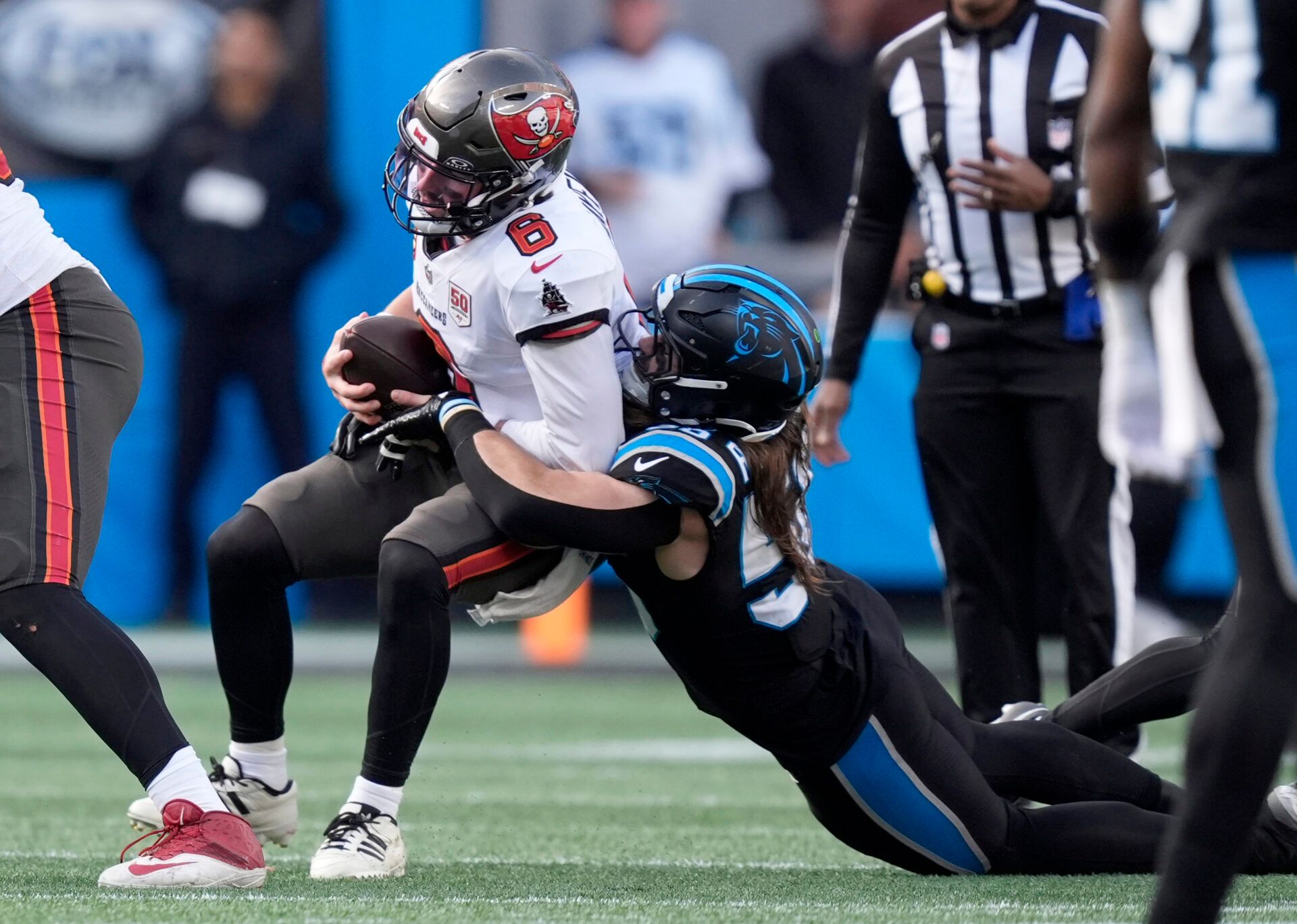 Carolina Panthers linebacker Christian Rozeboom (56) tackles Tampa Bay Buccaneers quarterback Baker Mayfield (6) during the second half at Bank of America Stadium.