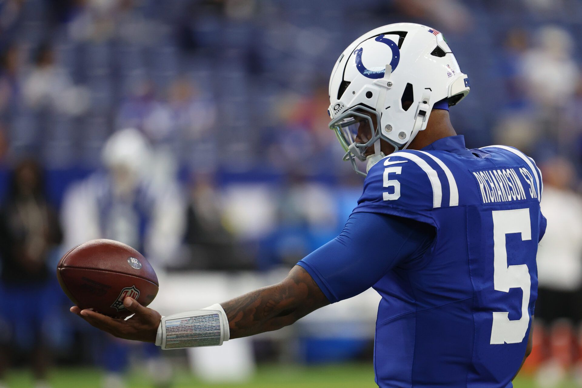Indianapolis Colts quarterback Anthony Richardson (5) holds a football during warmups before the game between the Las Vegas Raiders and the Indianapolis Colts at Lucas Oil Stadium.
