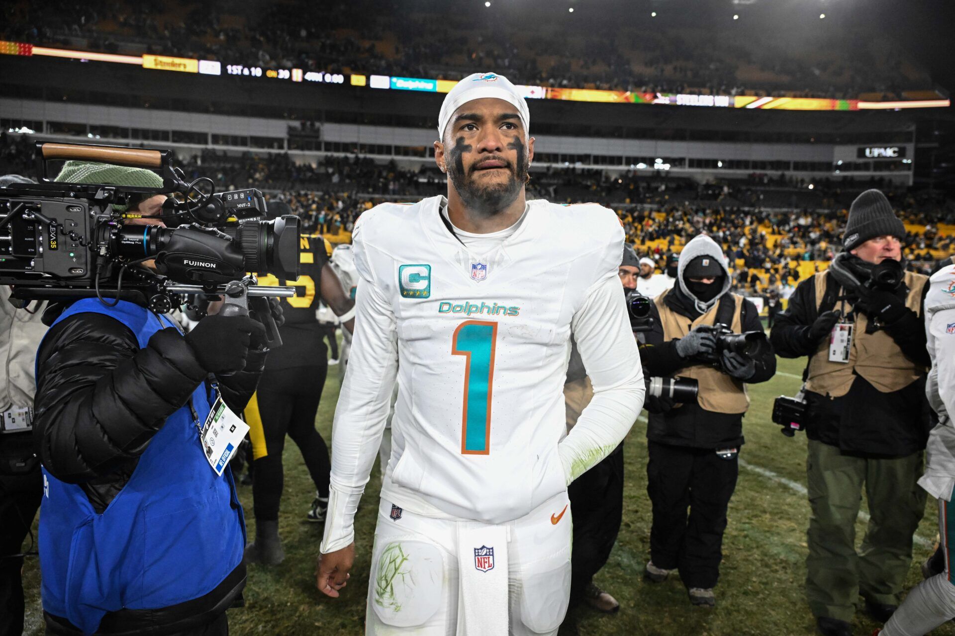 Miami Dolphins quarterback Tua Tagovailoa (1) leaves the  field following a game against the Pittsburgh Steelers at Acrisure Stadium.
