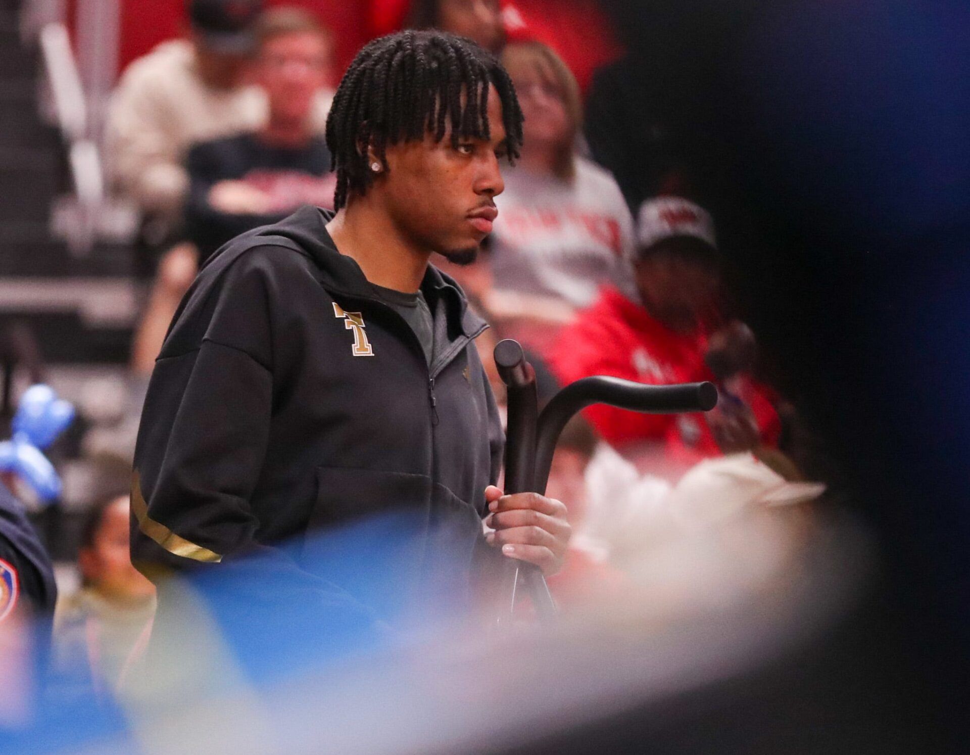 JT Toppin holds his crutches on the sideline as Texas Tech faces Kansas State in a Big 12 Conference men's basketball game, Saturday, Feb. 21, 2026, in United Supermarkets Arena.