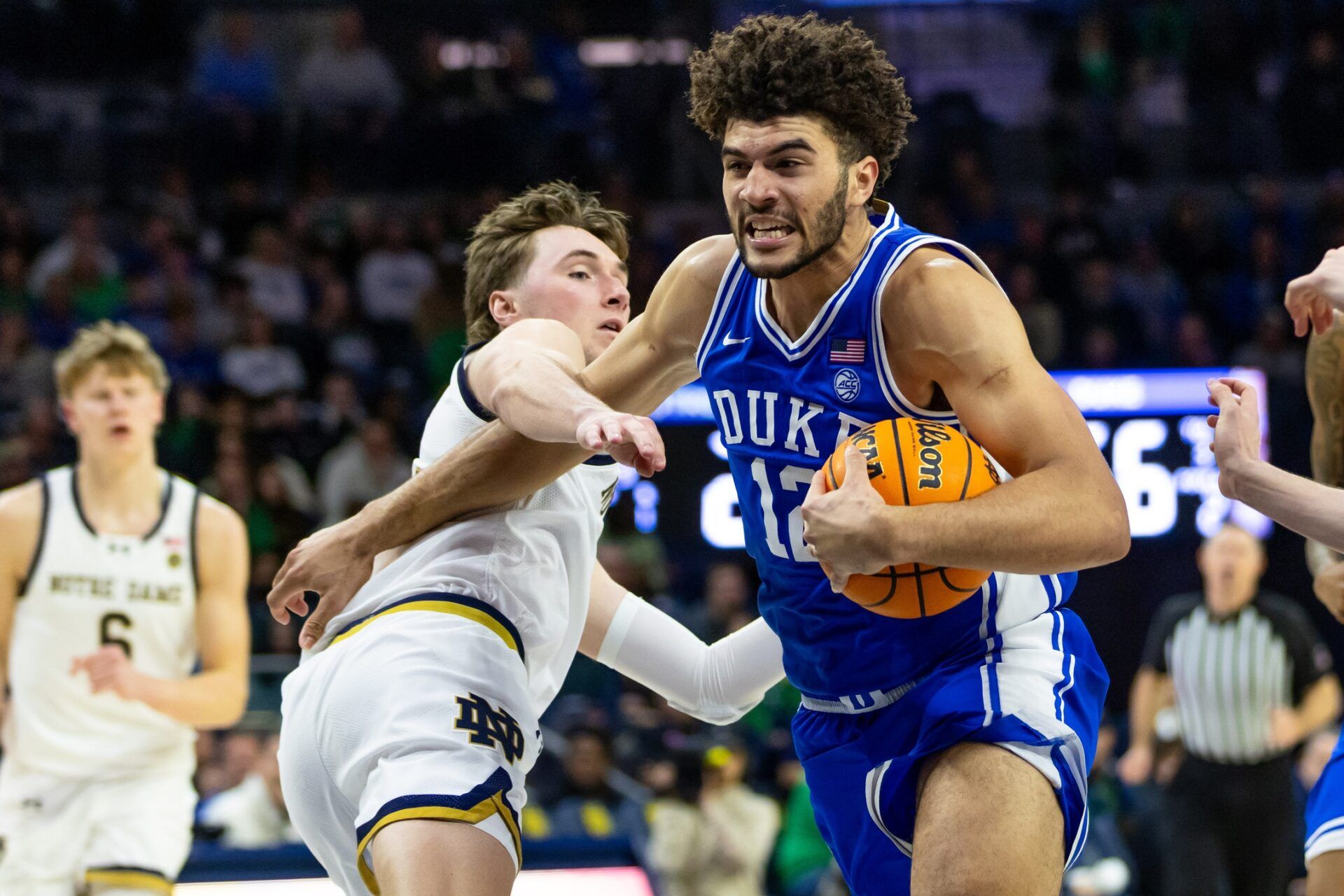 Duke Blue Devils forward Cameron Boozer (12) drives as Notre Dame Fighting Irish guard Cole Certa (5) defends during the second half at Purcell Pavilion at the Joyce Center.