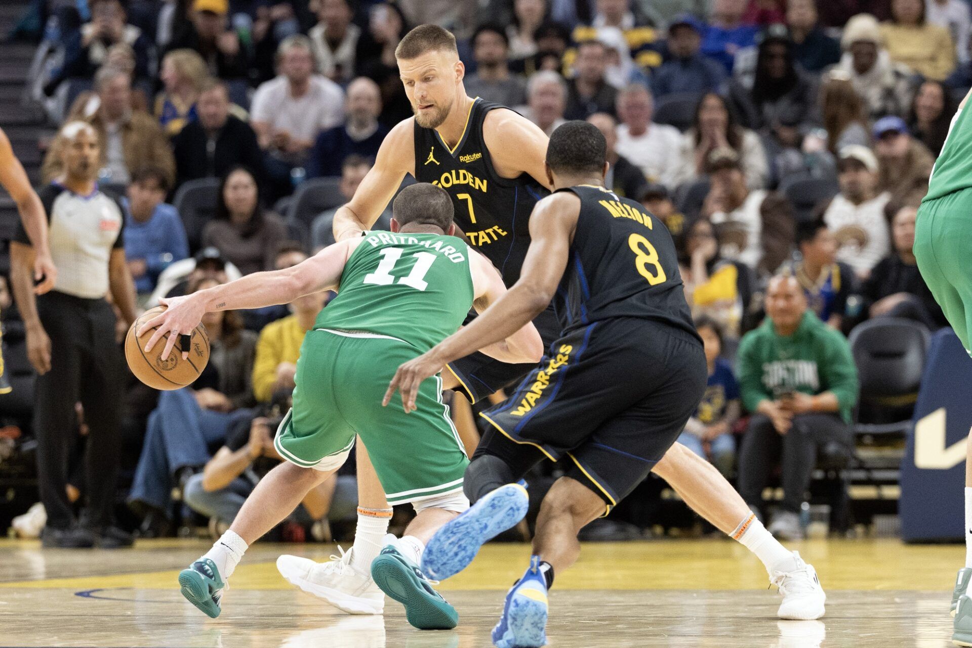 Golden State Warriors defenders  Kristaps Porzingis (7) and De'Anthony Melton (8) double-team Boston Celtics guard Payton Pritchard (11) during the fourth quarter at Chase Center.