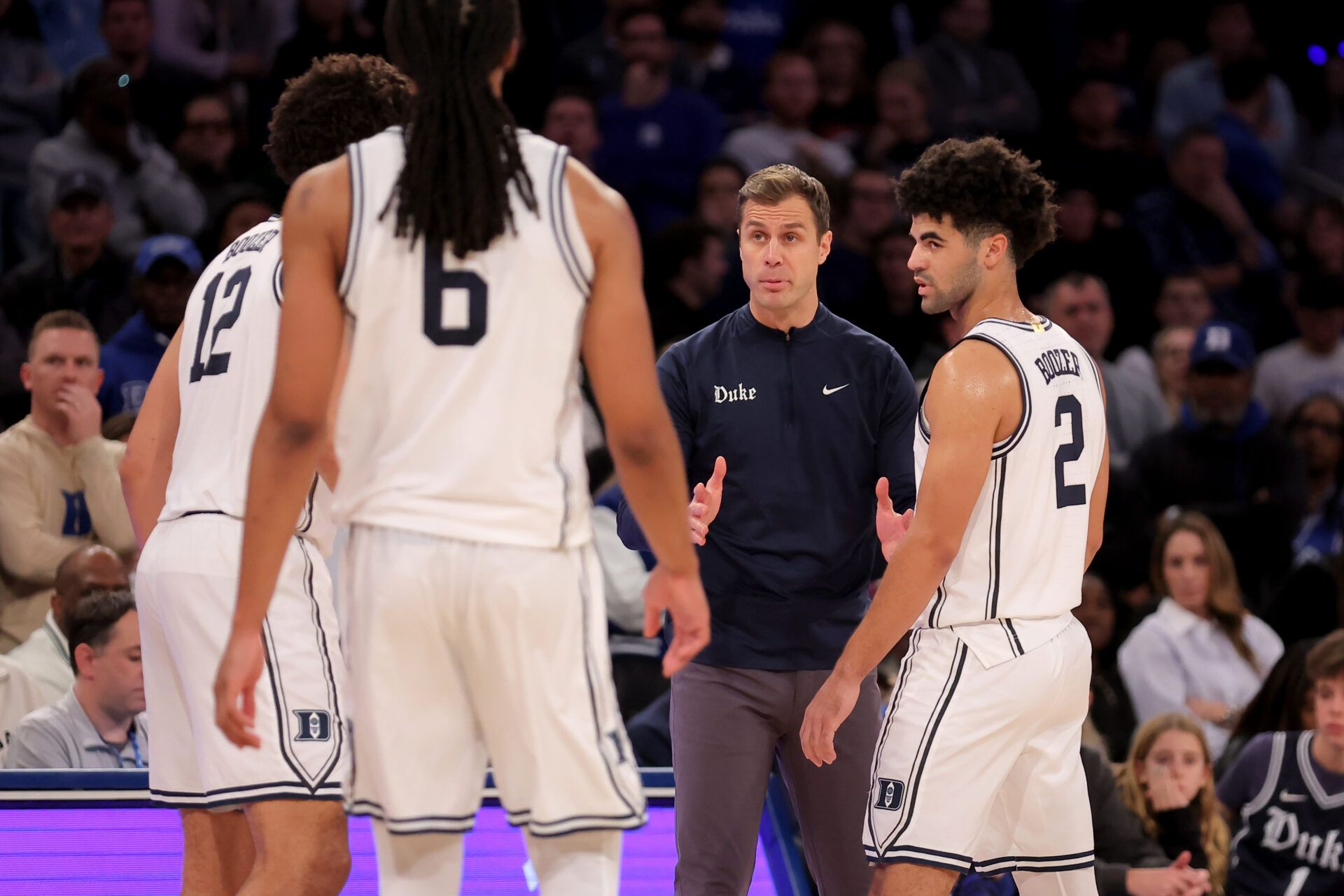 Duke Blue Devils head coach Jon Scheyer talks to Duke Blue Devils forwards Cameron Boozer (12) and Maliq Brown (6) and guard Cayden Boozer (2) during the second half against the Texas Tech Red Raiders at Madison Square Garden.