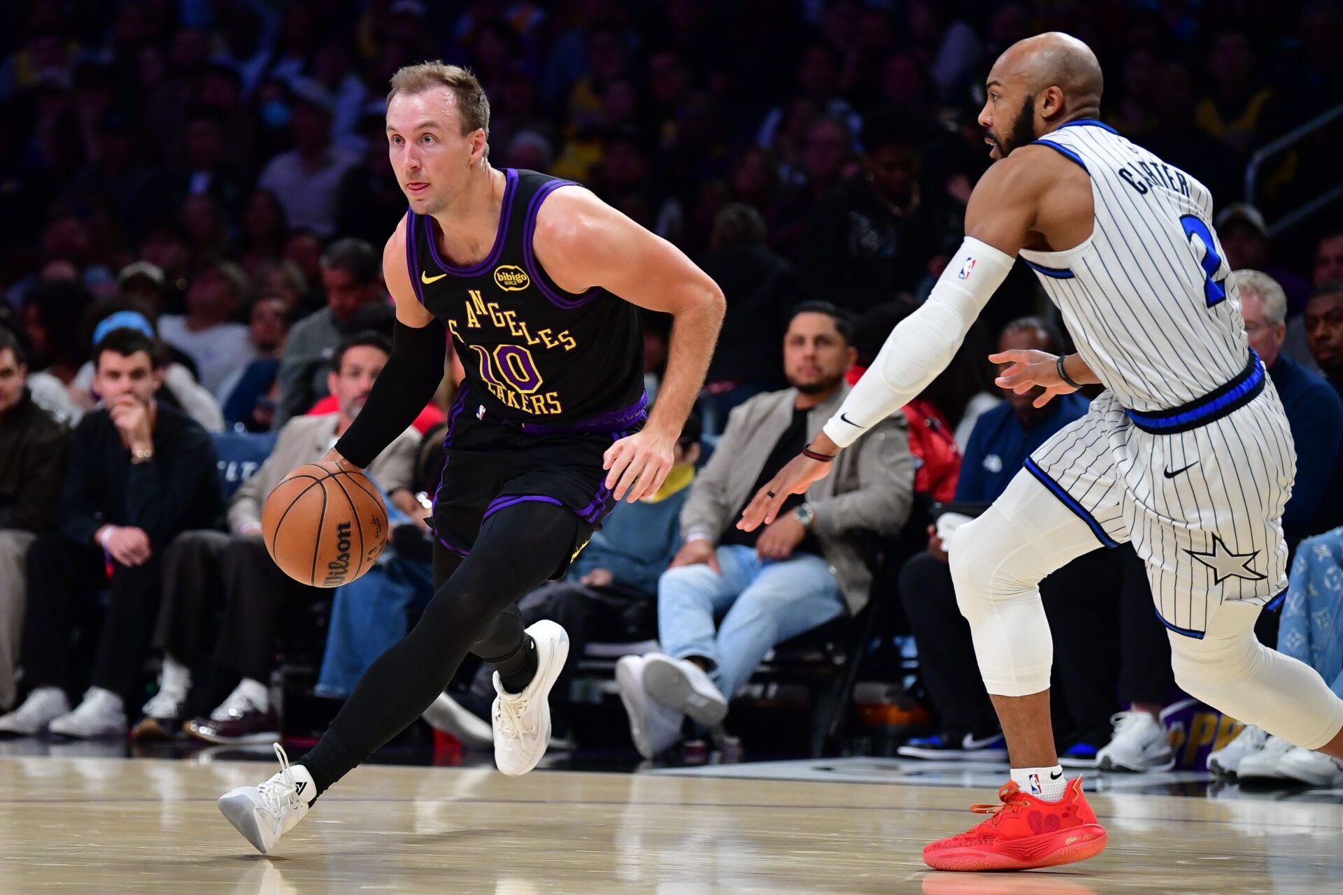 Los Angeles Lakers guard Luke Kennard (10) moves the ball against Orlando Magic guard Jevon Carter (2) during the second half at Crypto.com Arena.