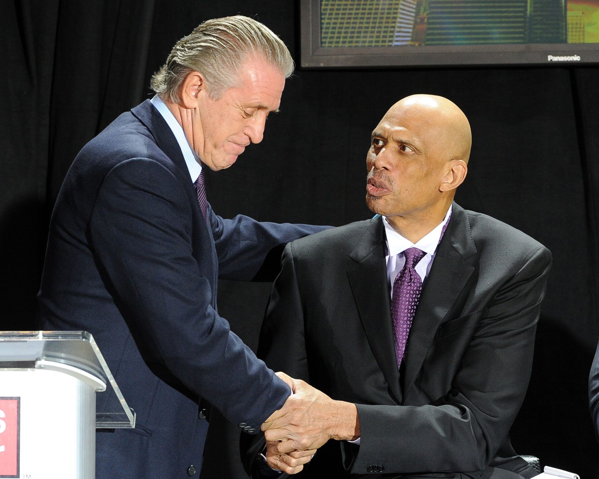 NBA coach Pat Riley shakes hands with Kareem Abdul-Jabbar after speaking during the ceremony unveiling the Kareem Abdul-Jabbar statue in front of the Staples Center.