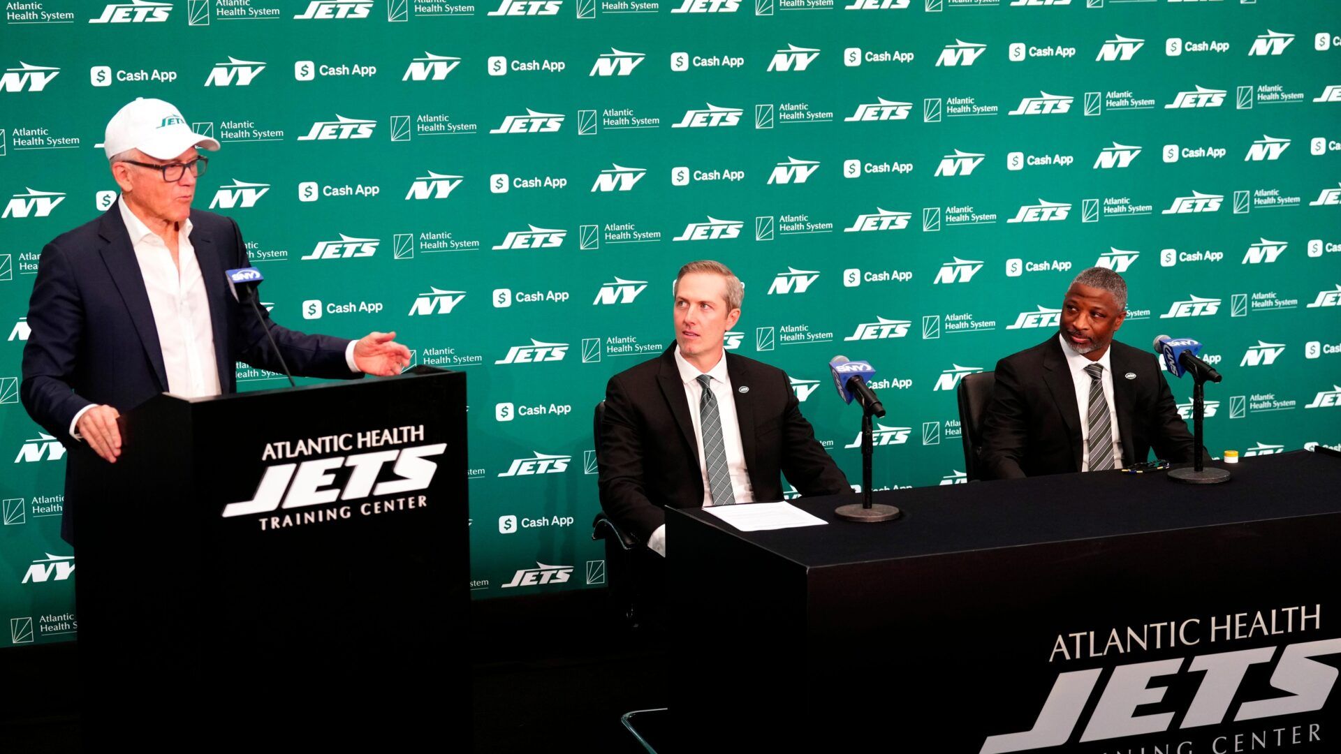 (STILL FOR VIDEO) New York Jets Owner Woody Johnson is shown at a press conference with his new general manager, Darren Mougey and new head coach, Aaron Glenn, Monday, January 27, 2025, in Florham Park.