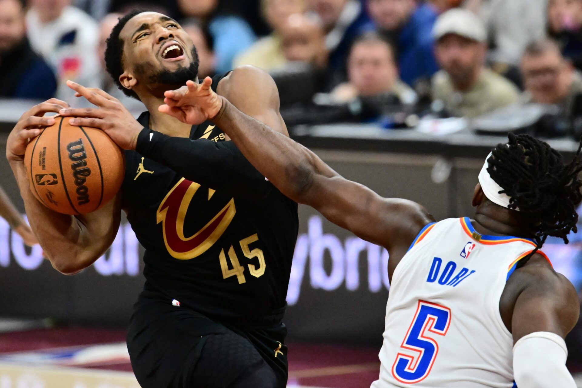 Cleveland Cavaliers guard Donovan Mitchell (45) drives to the basket against Oklahoma City Thunder guard Luguentz Dort (5) during the second half at Rocket Arena.