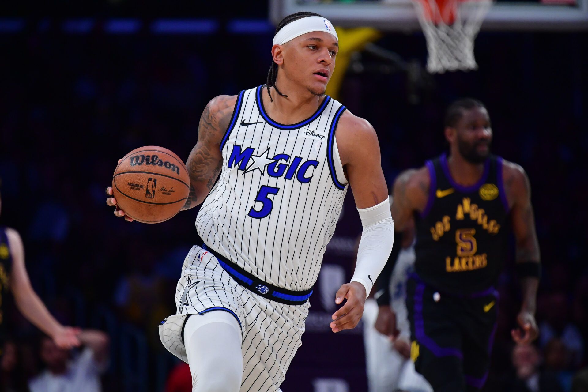 Orlando Magic forward Paolo Banchero (5) moves the ball up court against the Los Angeles Lakers during the first half at Crypto.com Arena.