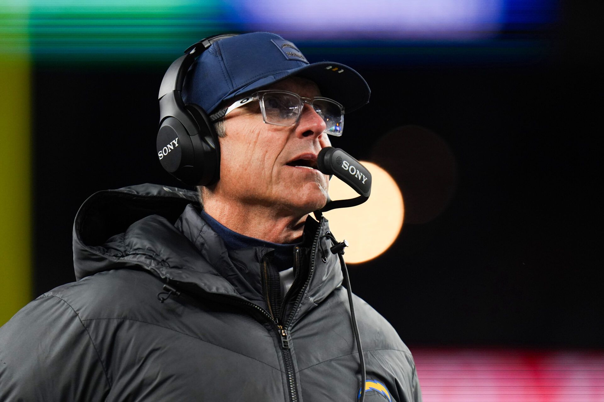 Los Angeles Chargers head coach Jim Harbaugh looks on during the second quarter against the New England Patriots in an AFC Wild Card Round game at Gillette Stadium.