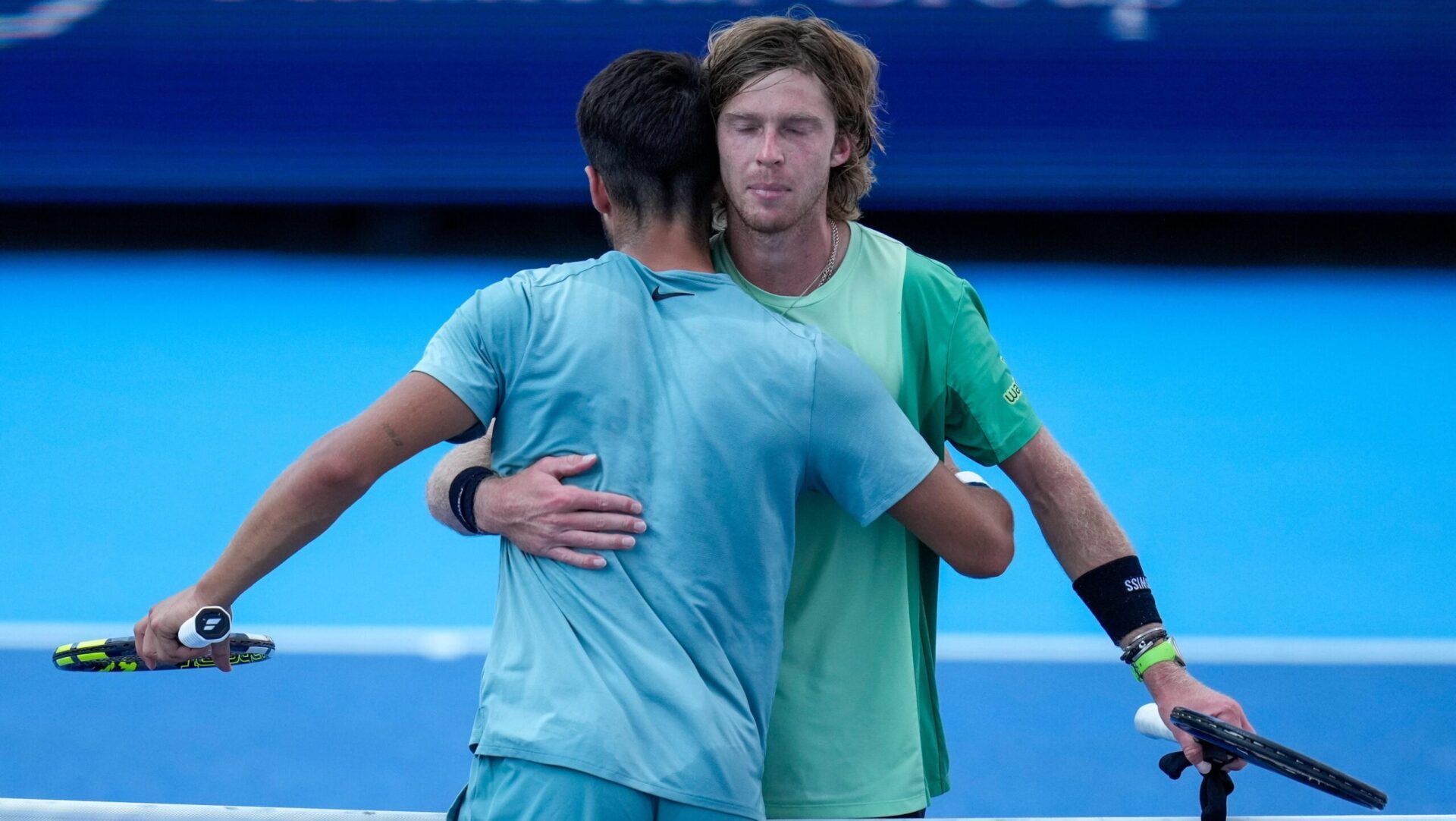 Andrey Rublev and Carlos Alcaraz hug after their Cincinnati Open quarterfinal match at the Lindner Family Tennis Center in Mason, Ohio, on Friday, Aug. 15, 2025. Alcaraz won, 6-3, 4-6, 7-5.