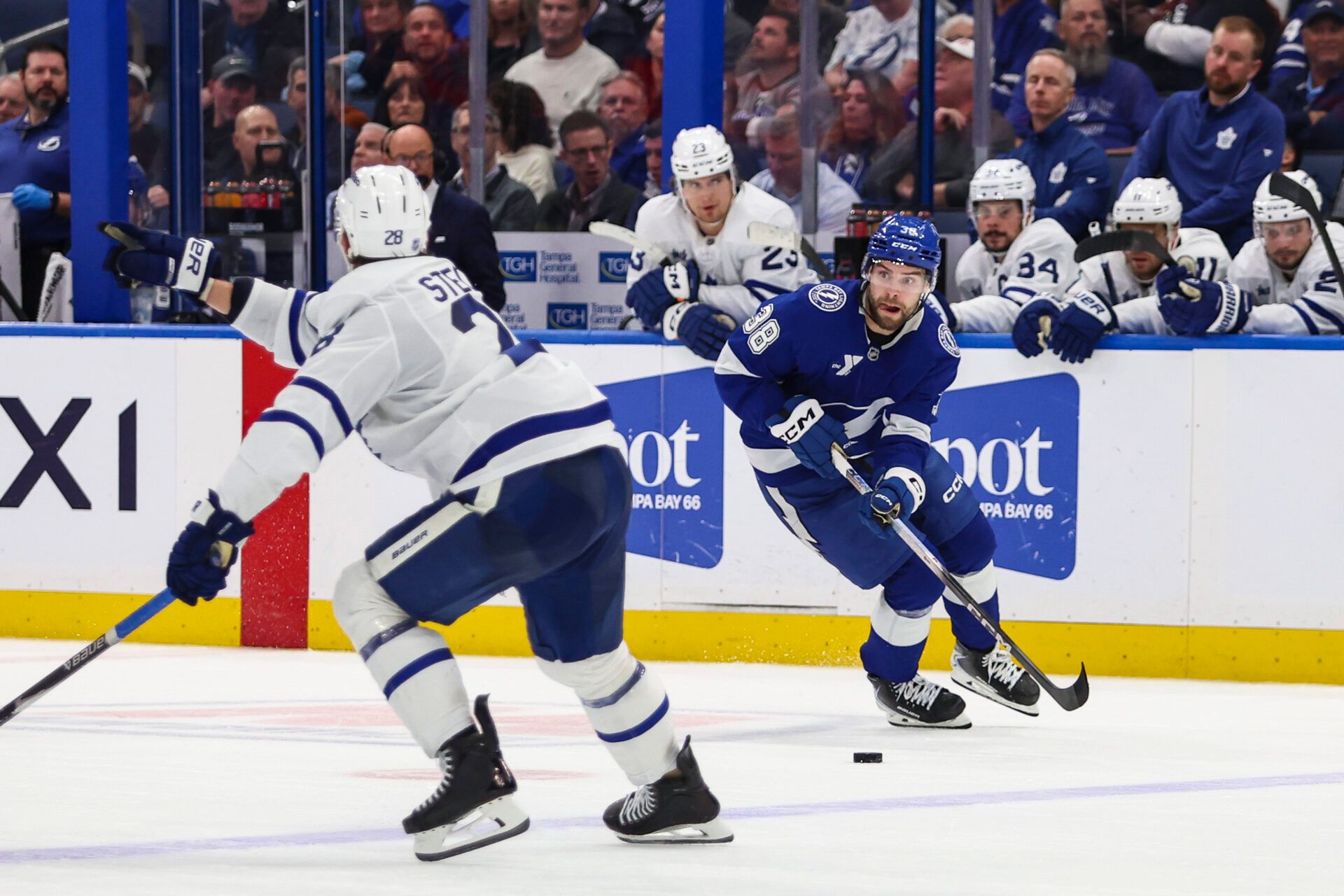 Tampa Bay Lightning forward Brandon Hagel (38) handles the puck against Toronto Maple Leafs defenseman Troy Stecher (28) during the third period at Benchmark International Arena.