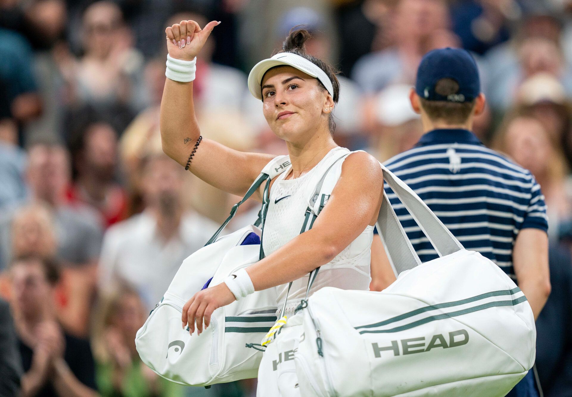 Bianca Andreescu (CAN) waves to the crowd as she leaves the court after her match against Ons Jabeur (TUN) on day six at the All England Lawn Tennis and Croquet Club.