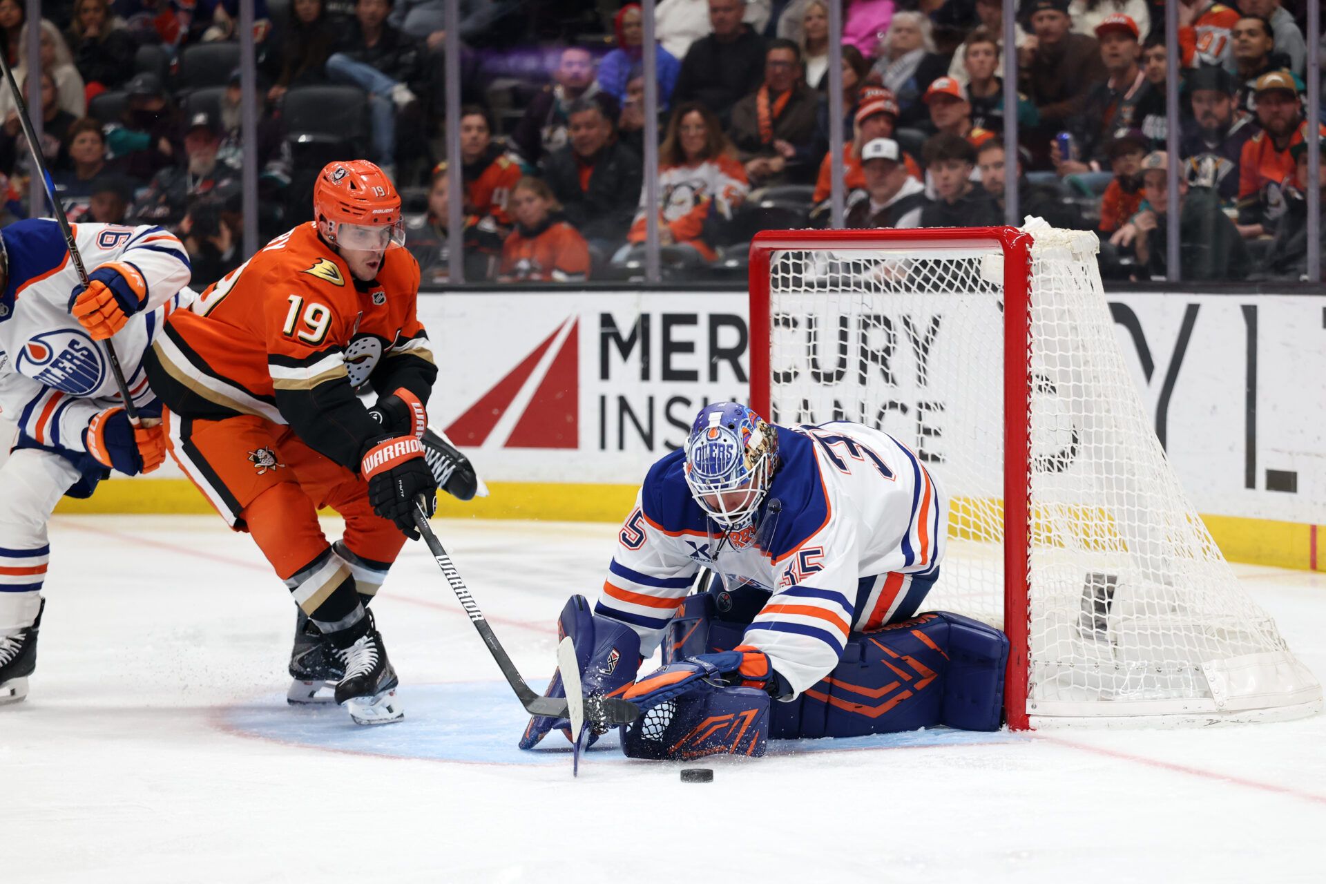 Edmonton Oilers goaltender Tristan Jarry (35) makes a save as Anaheim Ducks right wing Troy Terry (19) reaches for the puck during the second period at Honda Center.