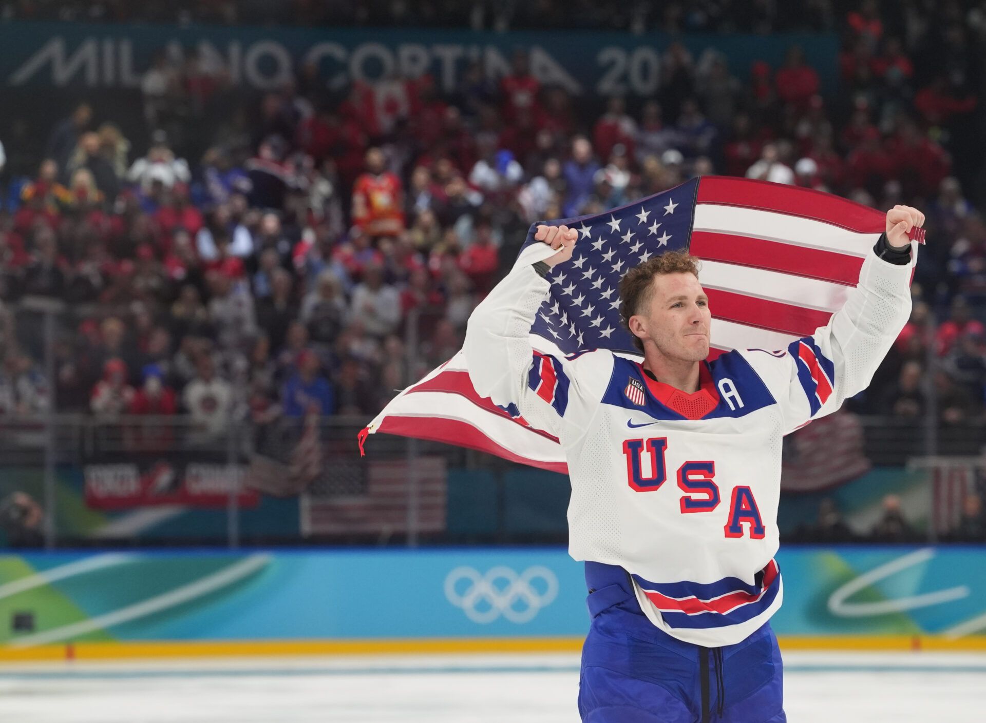 Matthew Tkachuk (19) of the United States celebrates after defeating Canada in the men's ice hockey gold medal game during the Milano Cortina 2026 Olympic Winter Games at Milano Santagiulia Ice Hockey Arena.