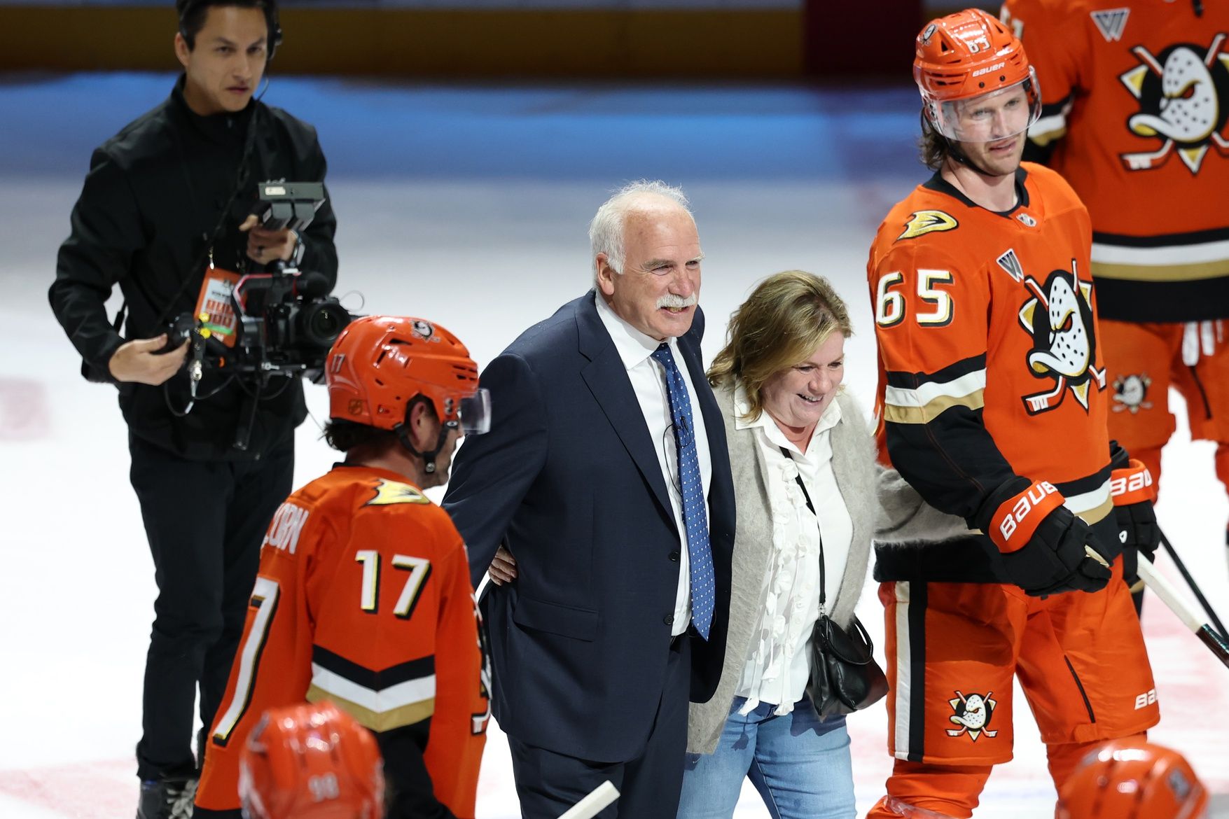 Anaheim Ducks head coach Joel Quenneville celebrates with his players after winning his 1,000th career coaching victory with a 6-5 win over the Edmonton Oilers at Honda Center.