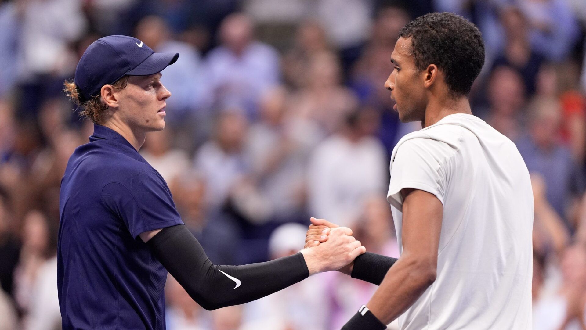 Jannik Sinner (left) (ITA) after beating Felix Auger-Aliassime (CAN) (right) on day thirteen of the 2025 U.S. Open tennis tournament at the USTA Billie Jean King National Tennis Center.
