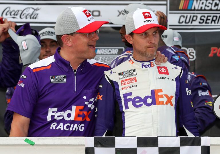 NASCAR Cup Series driver Denny Hamlin (right) is congratulated by crew chief Chris Gabehart (left) in victory lane after winning the M&MÕS Fan Appreciation 400 at Pocono Raceway.