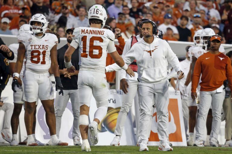 Texas Longhorns head coach Steve Sarkisian reacts with Texas Longhorns quarterback Arch Manning (16) during the fourth quarter against the Mississippi State Bulldogs at Davis Wade Stadium at Scott Field.