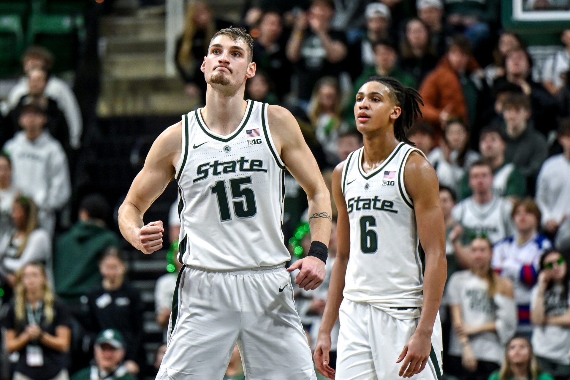 Michigan State's Carson Cooper, left, pumps his fist after time runs out in the Spartans win over Ohio State on Sunday, Feb. 22, 2026, at the Breslin Center in East Lansing. At right is teammate Jordan Scott. © Nick King/Lansing State Journal / USA TODAY NETWORK via Imagn Images