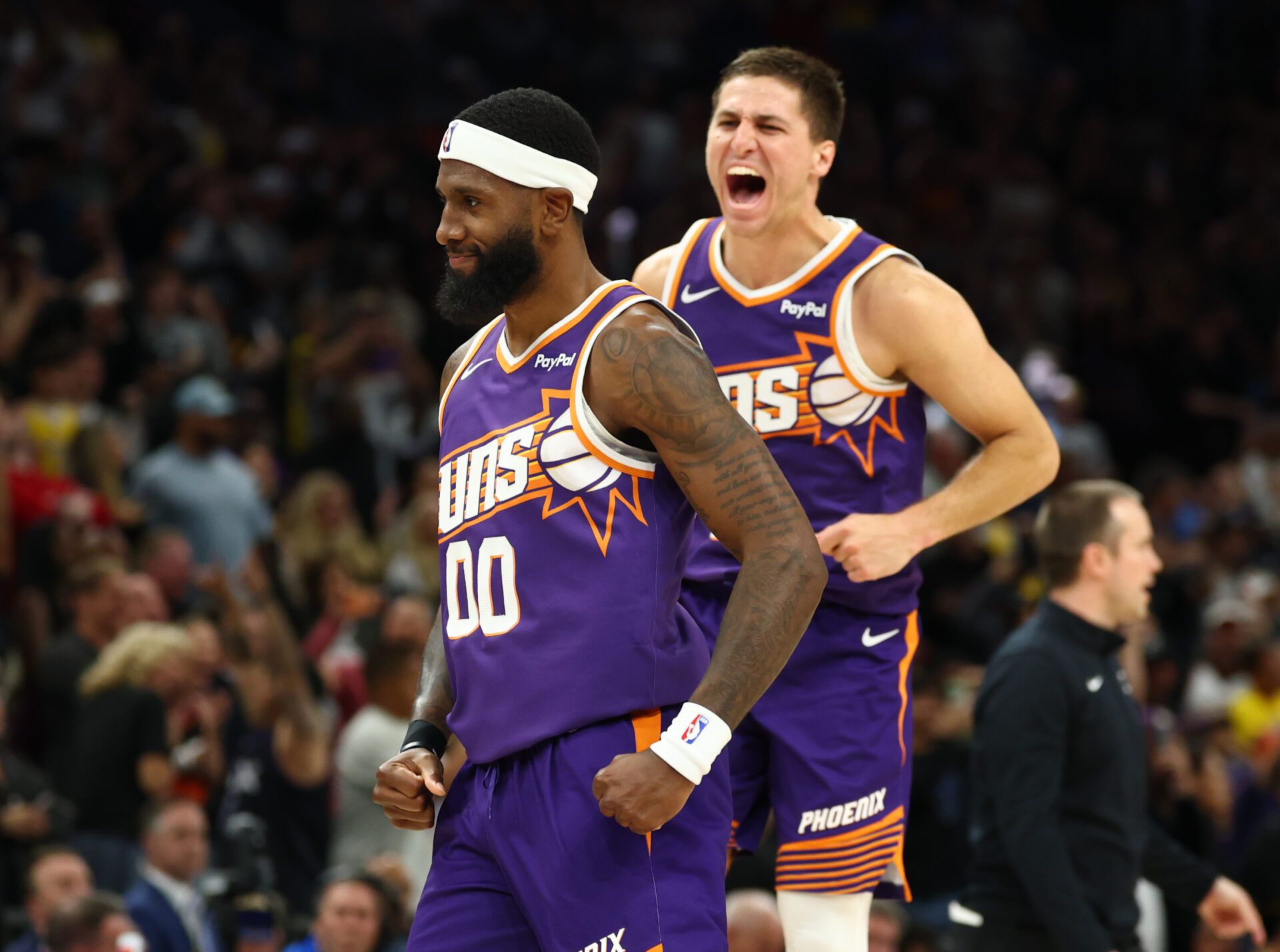 Phoenix Suns forward Royce O'Neale (00) celebrates with guard Collin Gillespie (12) against the Los Angeles Lakers in the second half at Mortgage Matchup Center.