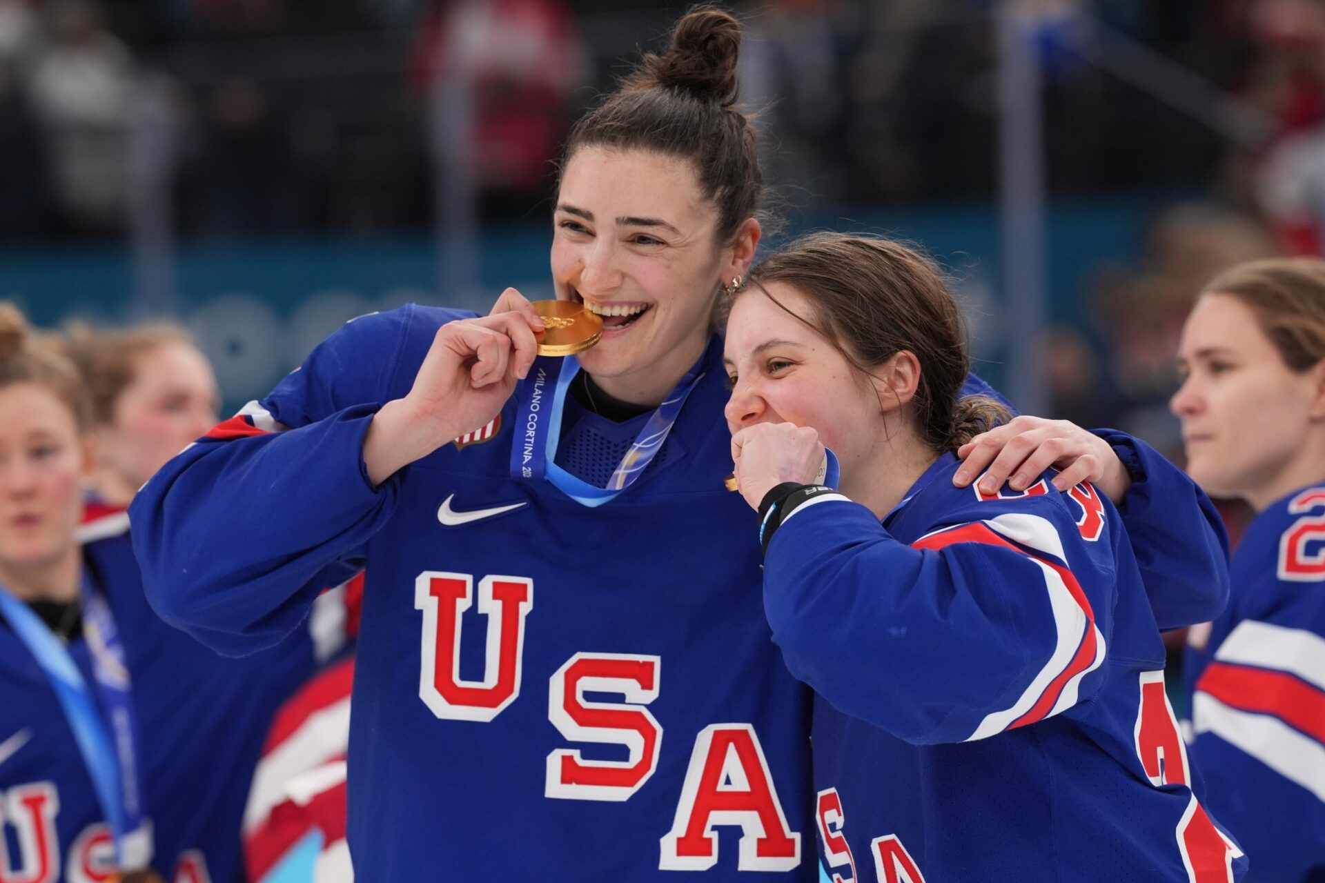 Megan Keller (5) of the United States and Hannah Bilka (23) of the United States celebrate after winning the gold medal in women's ice hockey after defeating Canada during the Milano Cortina 2026 Olympic Winter Games at Milano Santagiulia Ice Hockey Arena.