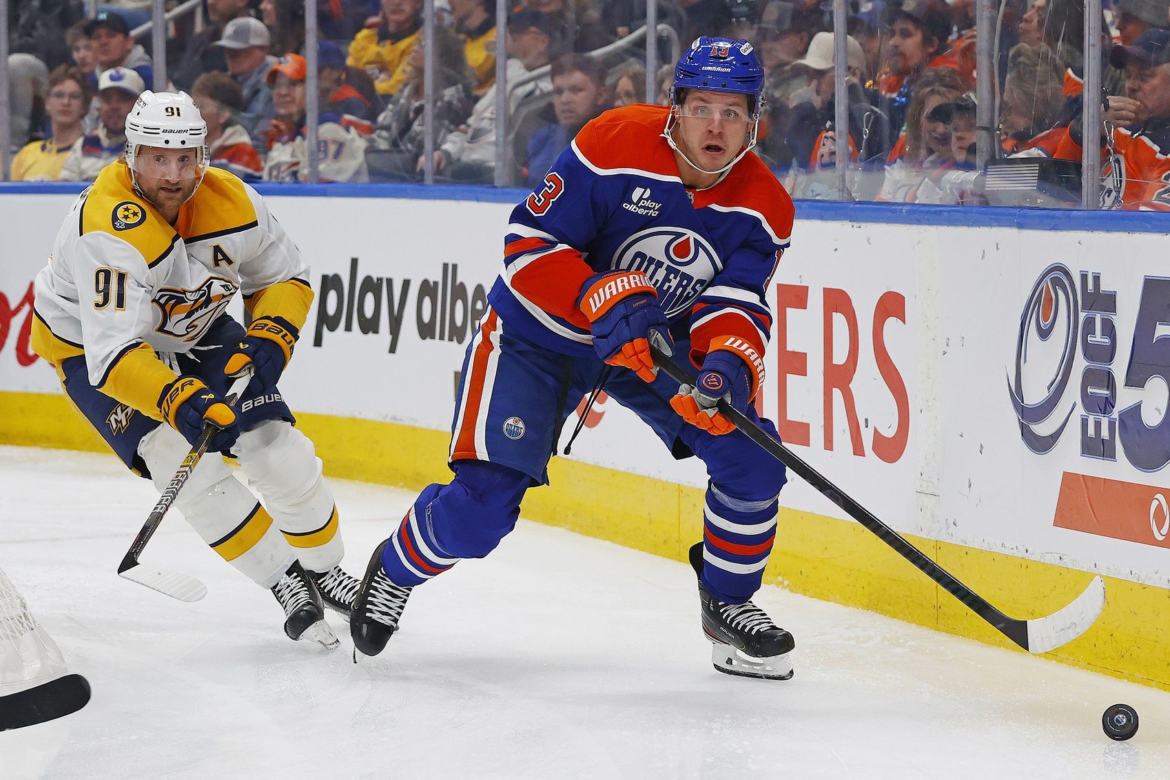Edmonton Oilers forward Mattias Janmark (13) looks to make a pass in front of Nashville Predators forward Steven Stamkos (91) during the third period at Rogers Place.