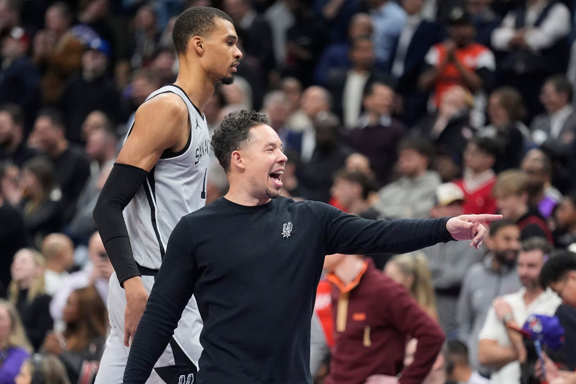 San Antonio Spurs head coach Mitch Johnson gestures to a player as center Victor Wembanyama (1) walks by during a break in the action against the Toronto Raptors the second half at Scotiabank Arena.