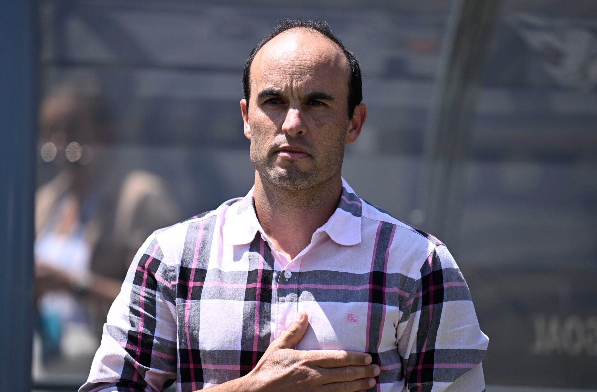 San Diego Wave FC interim head coach Landon Donovan stands for the national anthem before a match against Angel City FC at Snapdragon Stadium.