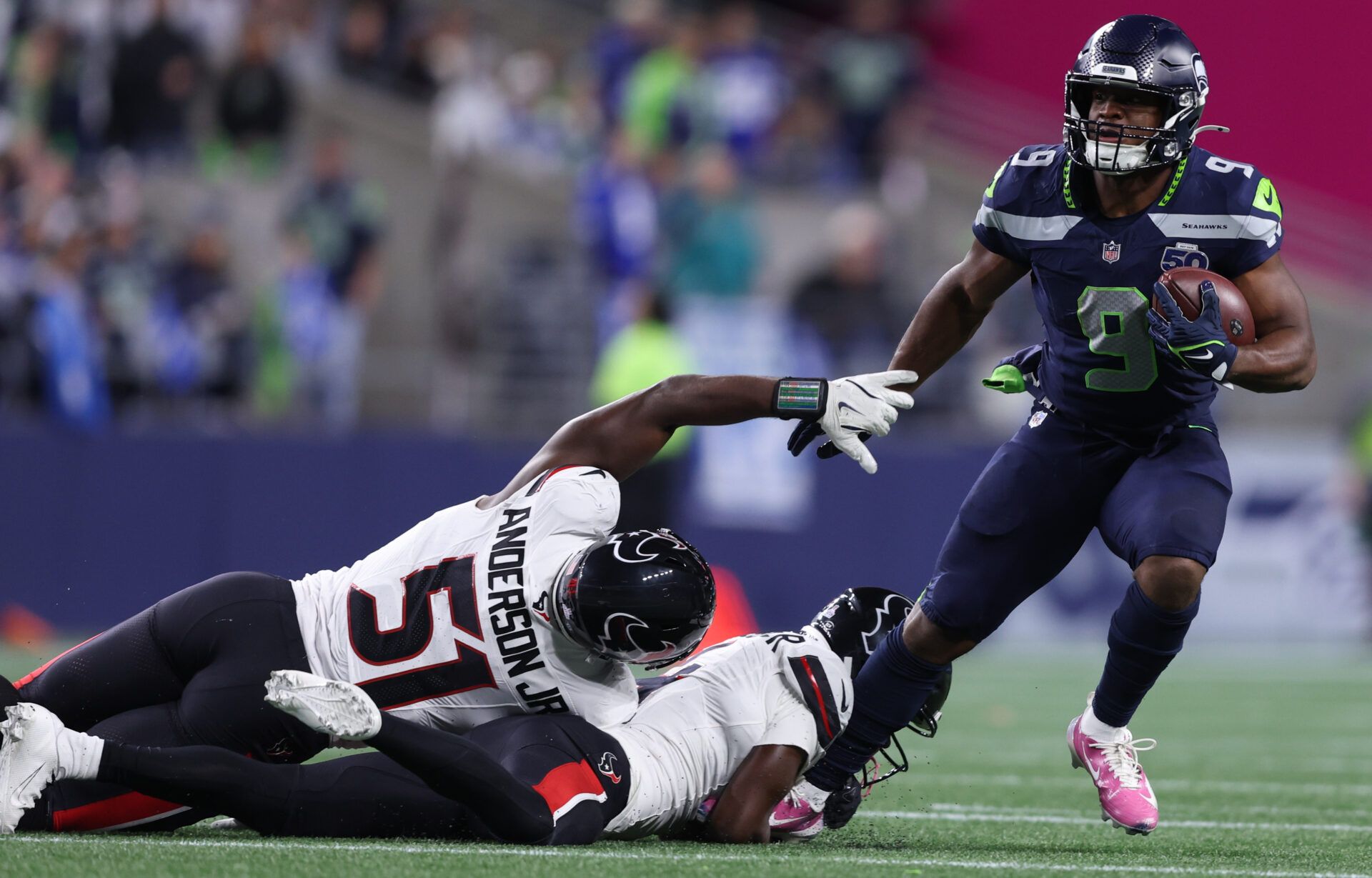 Seattle Seahawks running back Kenneth Walker III (9) runs the ball past Houston Texans defensive end Will Anderson Jr. (51) during the first quarter at Lumen Field.