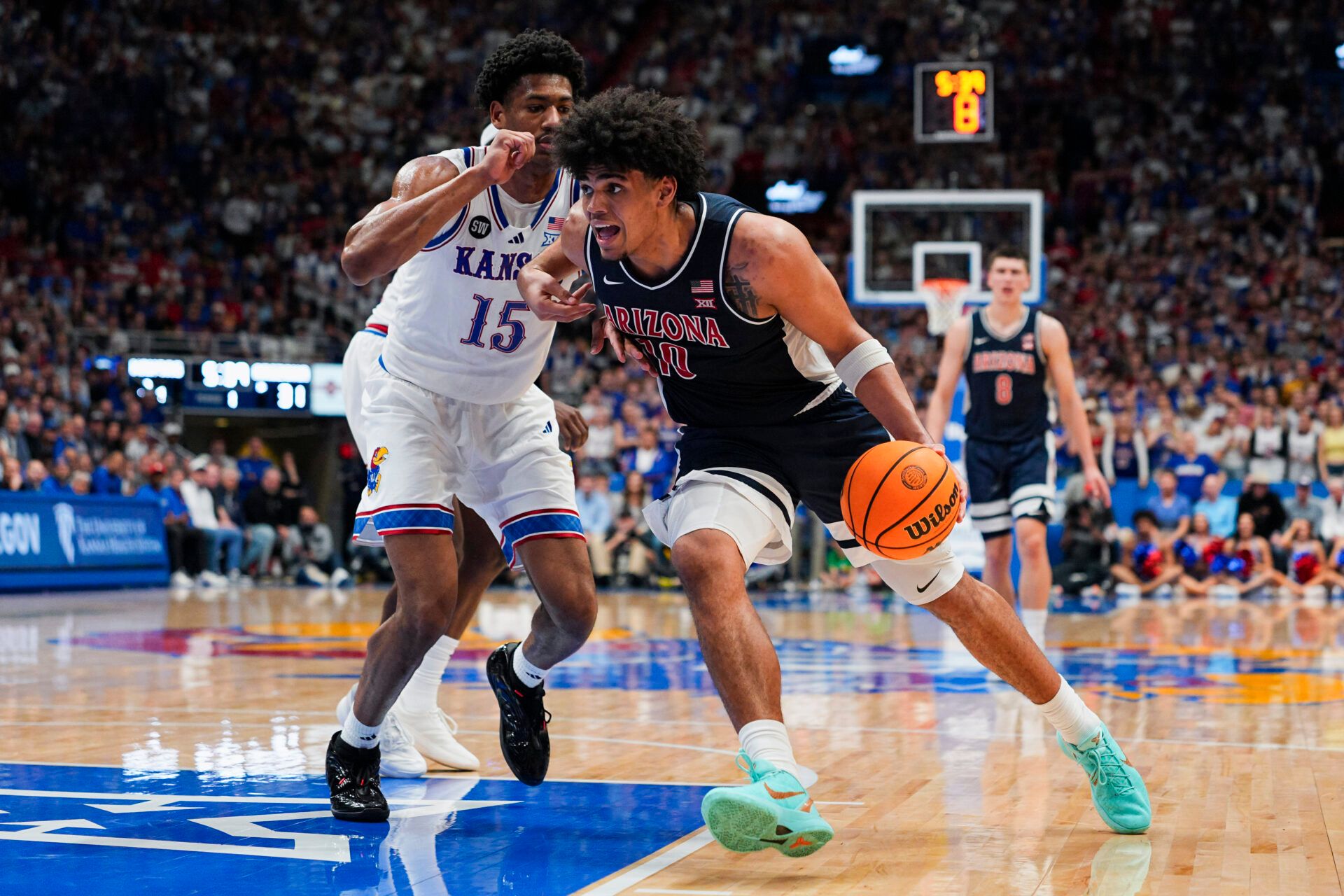 Arizona Wildcats forward Koa Peat (10) drives against Kansas Jayhawks forward Bryson Tiller (15) during the first half at Allen Fieldhouse.