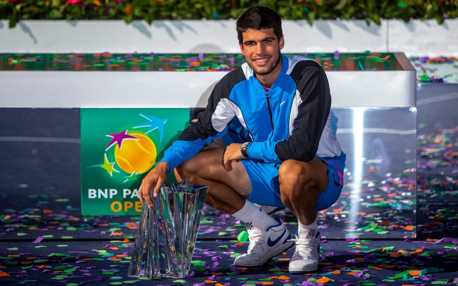 Carlos Alcaraz poses with the trophy after winning the ATP final of the BNP Paribas Open in Indian Wells, Calif., Sunday, March 17, 2024.