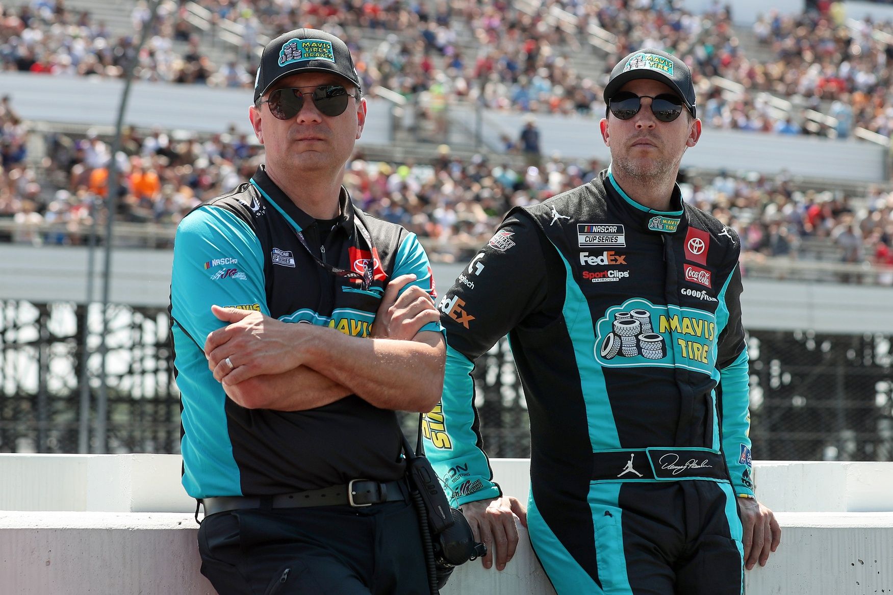 NASCAR Cup Series driver Denny Hamlin (right) stands with his crew chief Chris Gabehart (left) on pit road prior to The Great American Getaway 400 at Pocono Raceway.