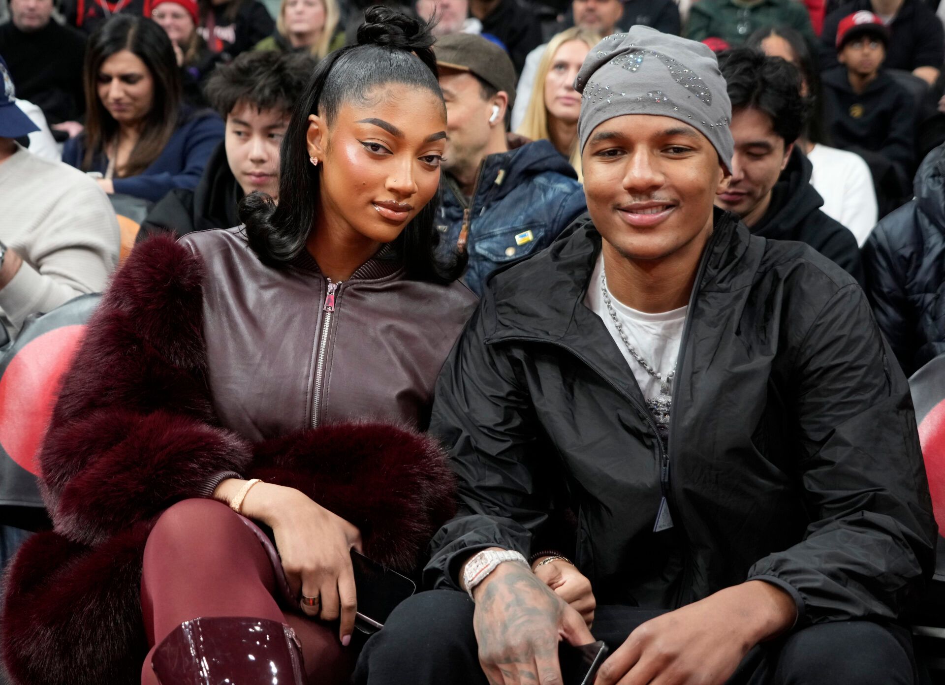 Chicago Sky player Angel Reese (left) sits with her brother Julian Reese (right) of the Raptors 905 during a game between the Orlando Magic and Toronto Raptors at Scotiabank Arena.