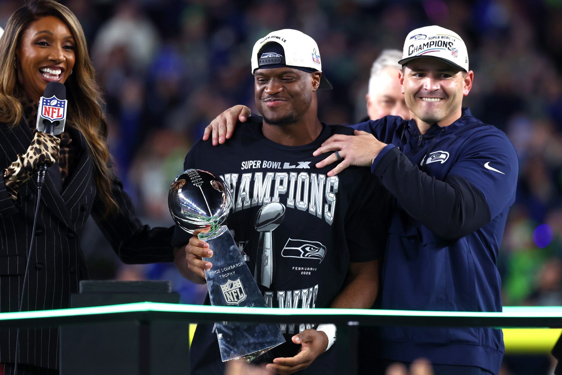 Seattle Seahawks head coach Mike MacDonald and running back Kenneth Walker III (9) celebrate with the Vince Lombardi trophy after defeating the New England Patriots in Super Bowl LX at Levi's Stadium.