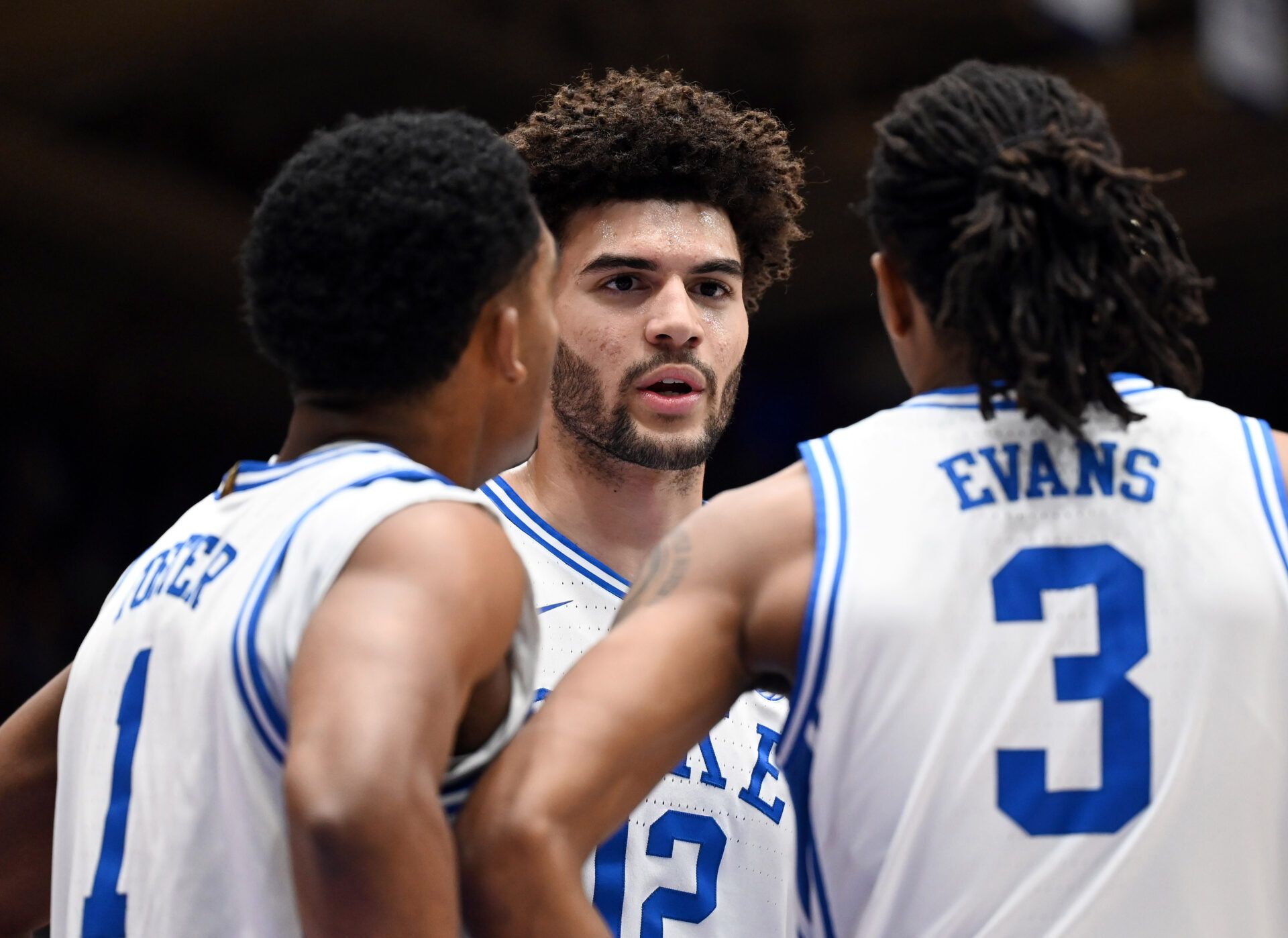 Duke Blue Devils forward Cameron Boozer (12) huddles with teammates Caleb Foster (1) and Isaiah Evans (3) during the first half against the Clemson Tigers at Cameron Indoor Stadium.