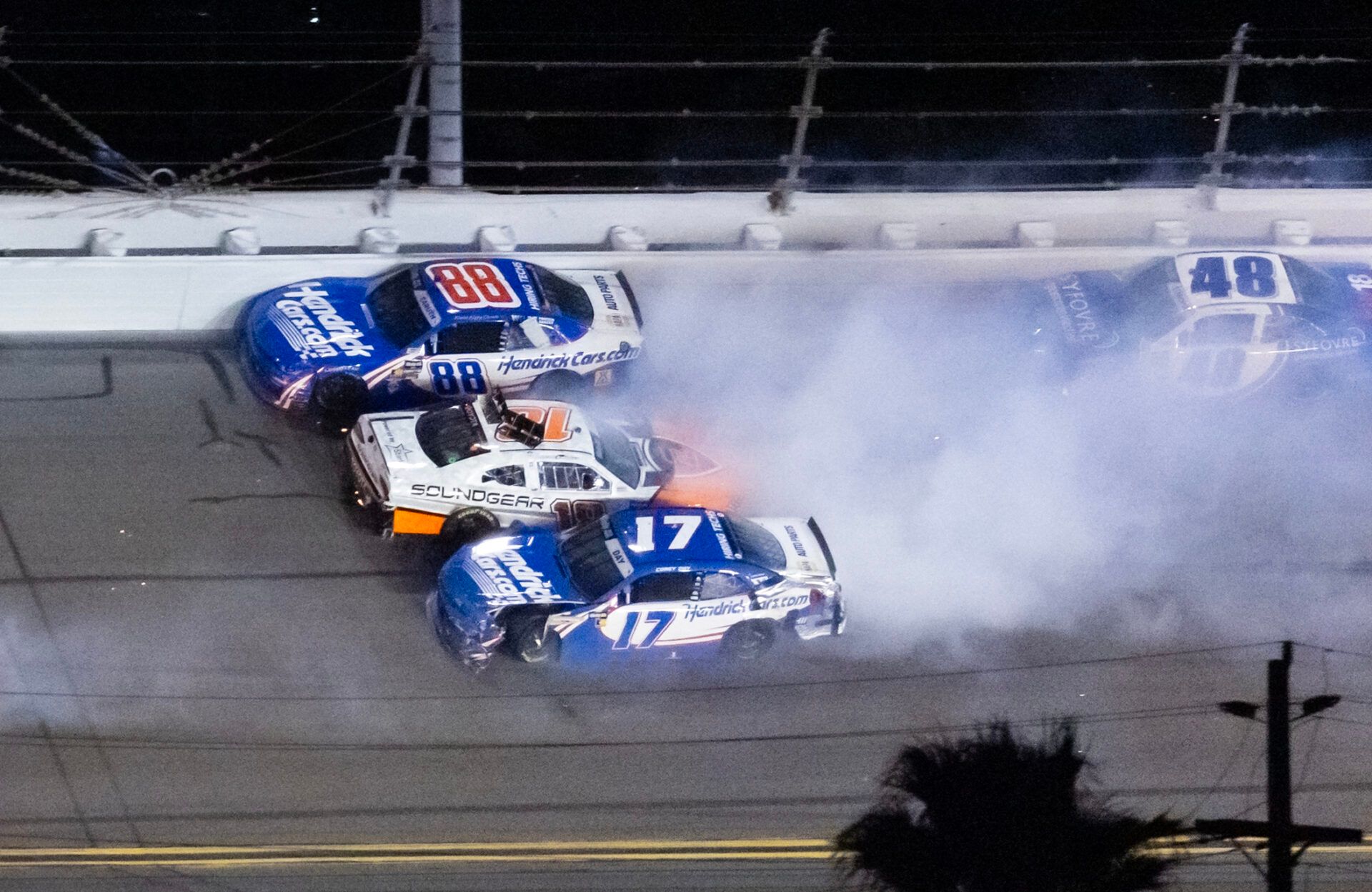 NASCAR OÕReilly Auto Parts Series drivers Rajah Caruth (88), William Sawalich (18) and Corey Day (17) crash during the United Rentals 300 at Daytona International Speedway.