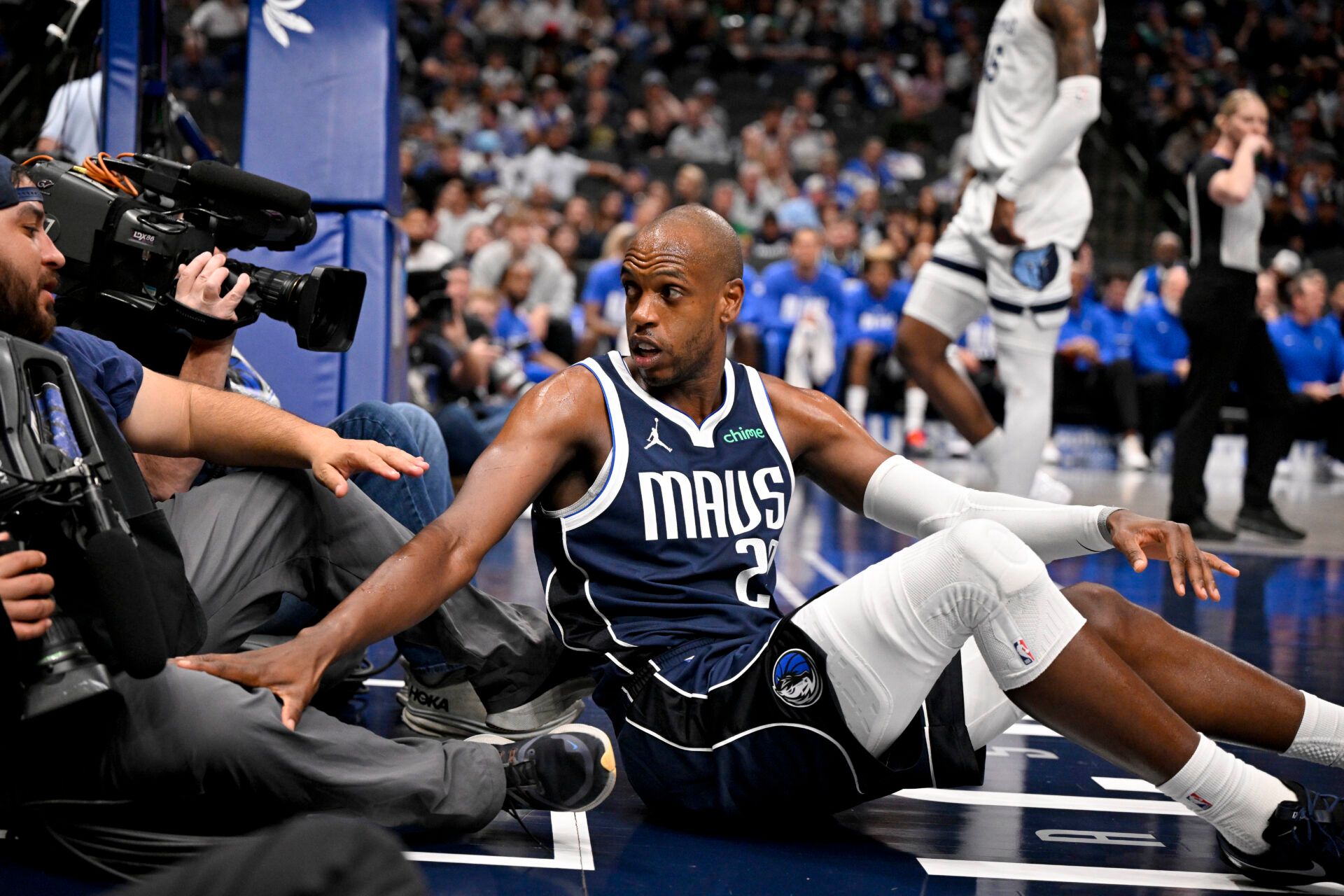 Dallas Mavericks forward Khris Middleton (20) checks on a tv cameraman after Middleton collides with him on the floor during the second half against the Memphis Grizzlies at the American Airlines Center.