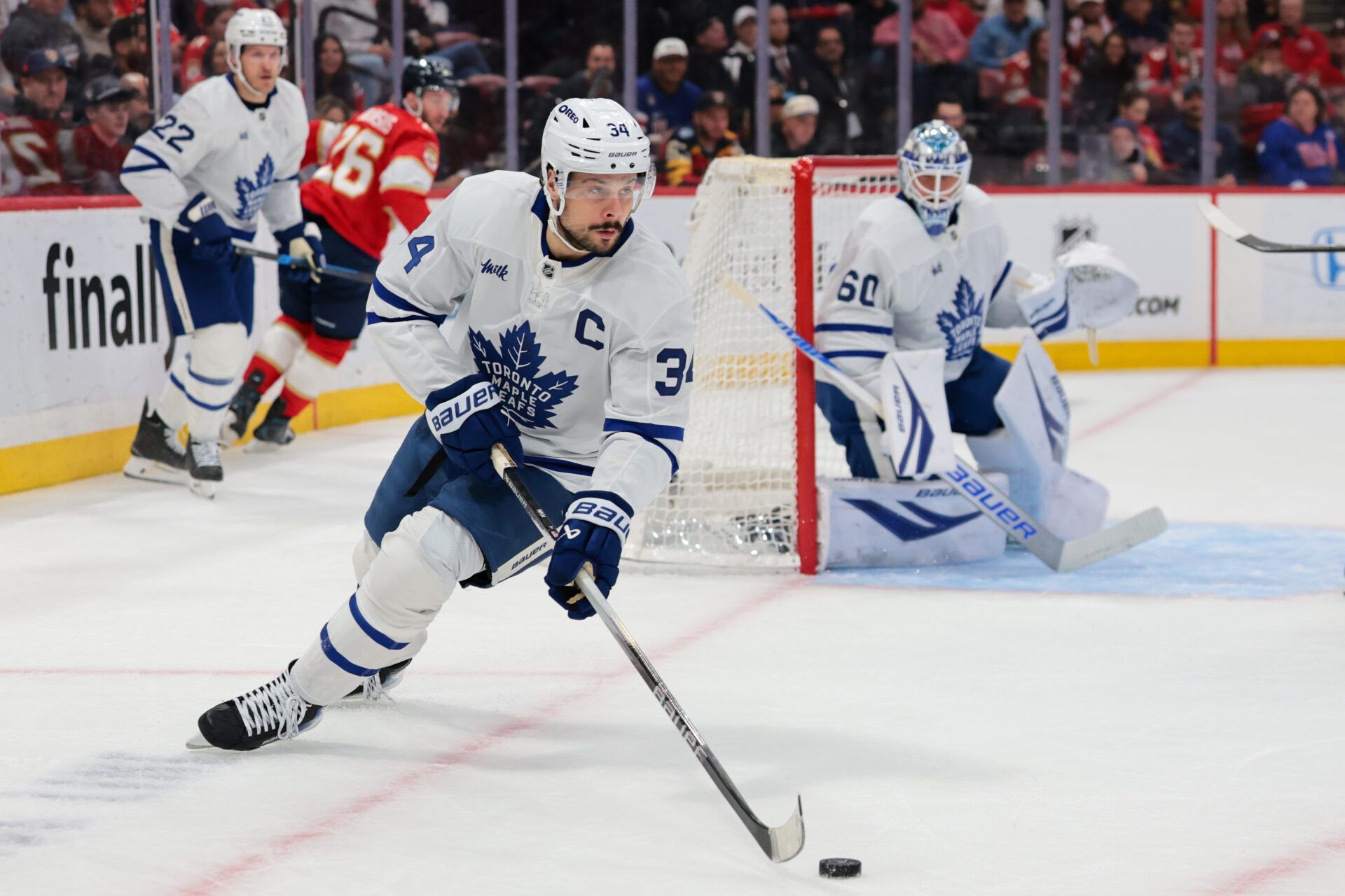 Toronto Maple Leafs center Auston Matthews (34) moves the puck against the Florida Panthers during the first period at Amerant Bank Arena.