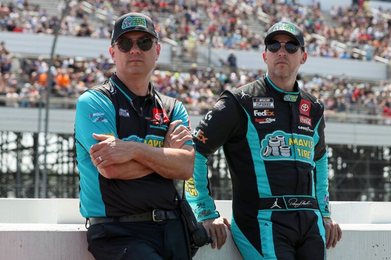 NASCAR Cup Series driver Denny Hamlin (right) stands with his crew chief Chris Gabehart (left) on pit road prior to The Great American Getaway 400 at Pocono Raceway.