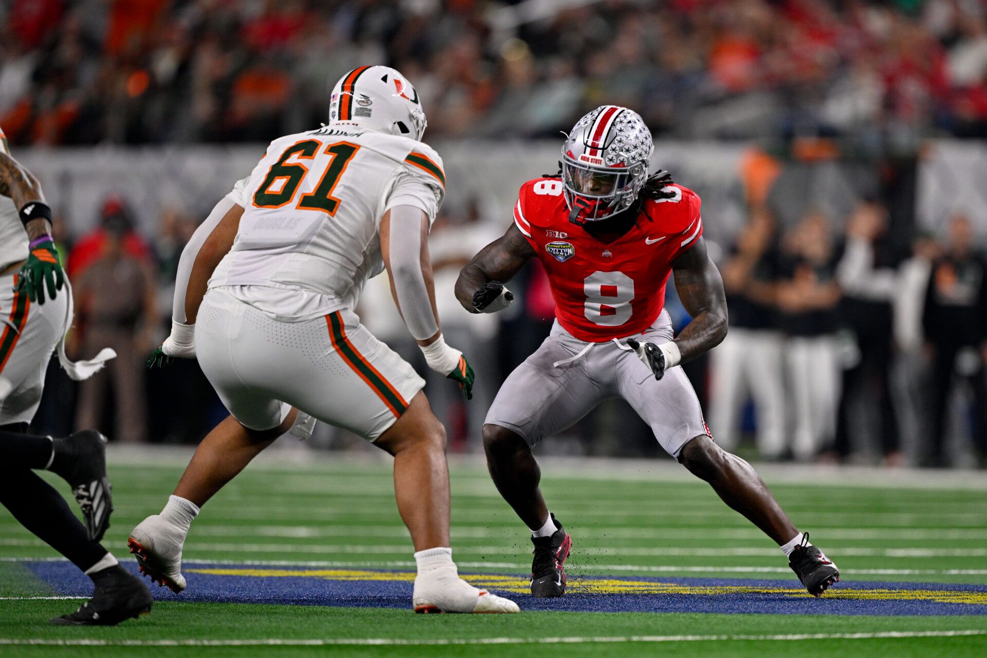 Miami Hurricanes offensive lineman Francis Mauigoa (61) blocks Ohio State Buckeyes linebacker Arvell Reese (8) during the 2025 Cotton Bowl and quarterfinal game of the College Football Playoff at AT&T Stadium.